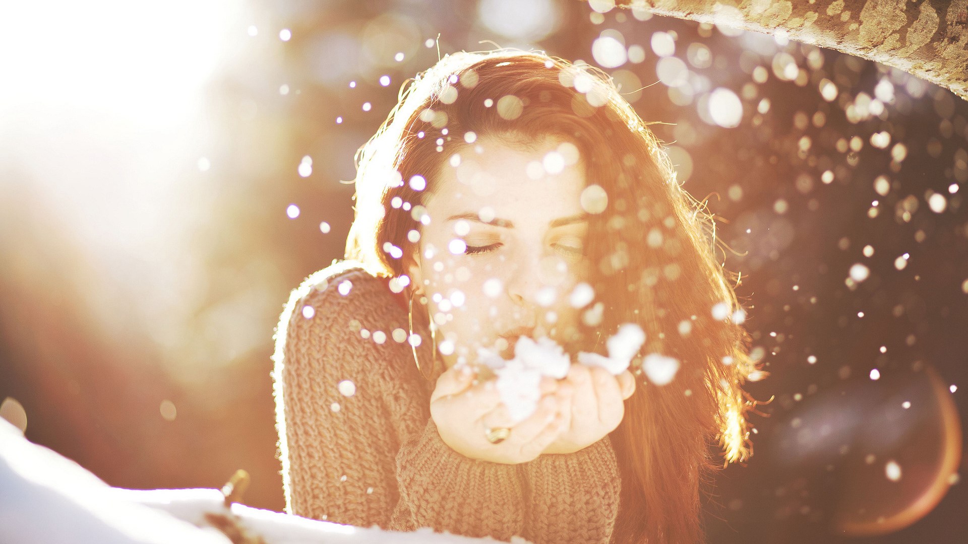 Woman blowing snow in a winter scene HD Wallpaper