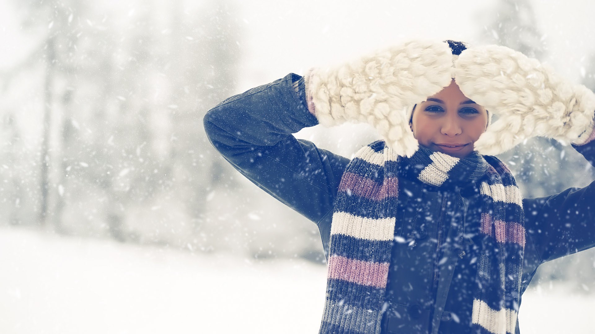 Woman in winter clothes holding large mittens HD Wallpaper