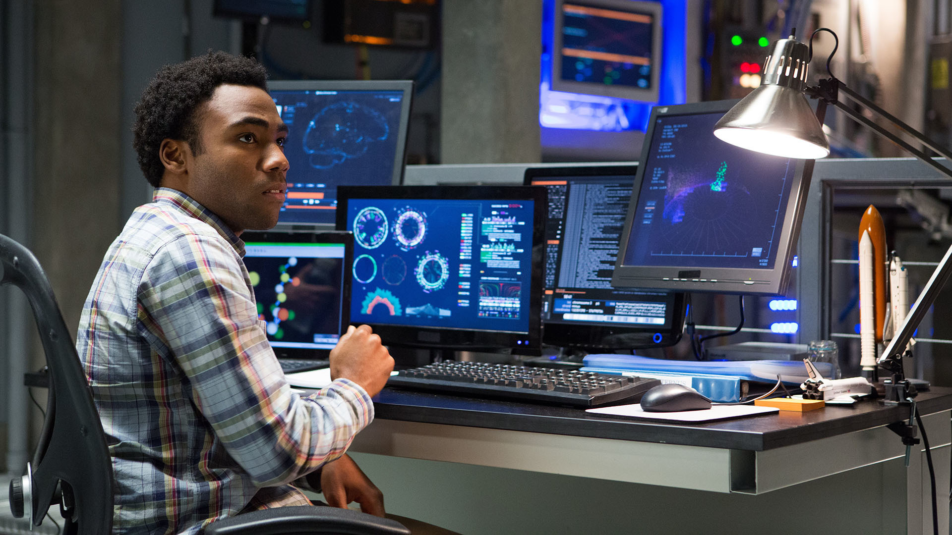 Donald Glover in a control room with multiple monitors HD Wallpaper