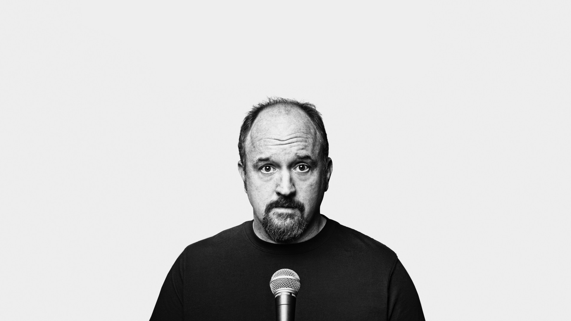 Louis C.K. with microphone HD Wallpaper