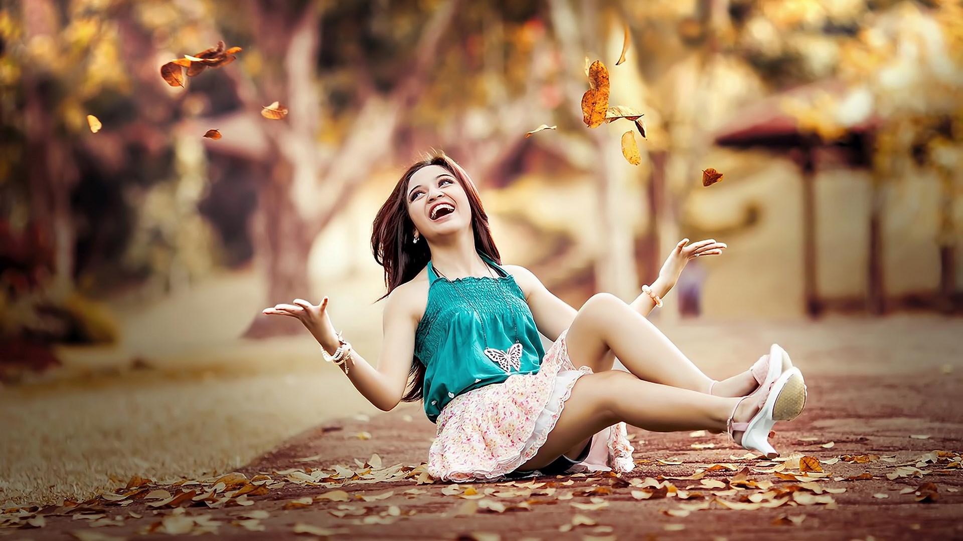 Woman laughing and throwing leaves in the air HD Wallpaper