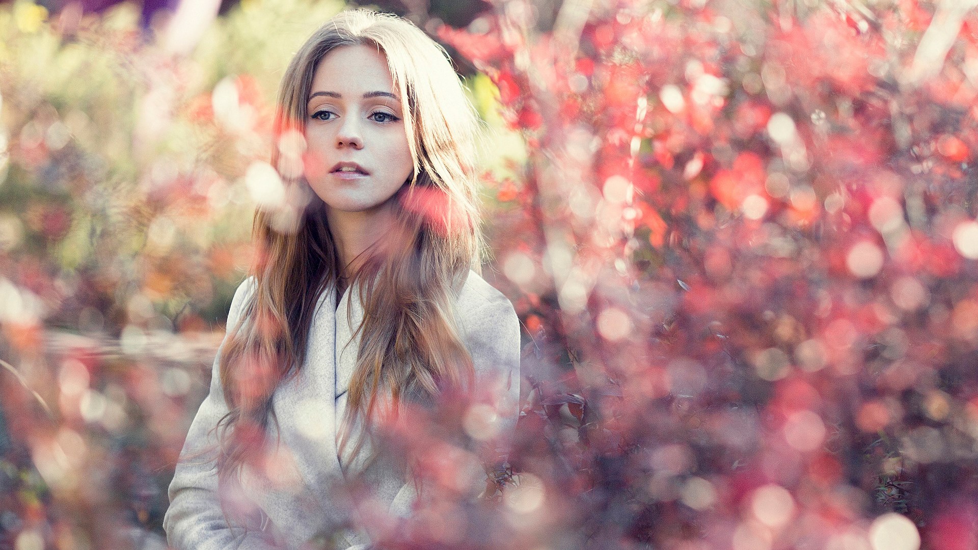 Young woman with blonde hair in a coat outdoors HD Wallpaper