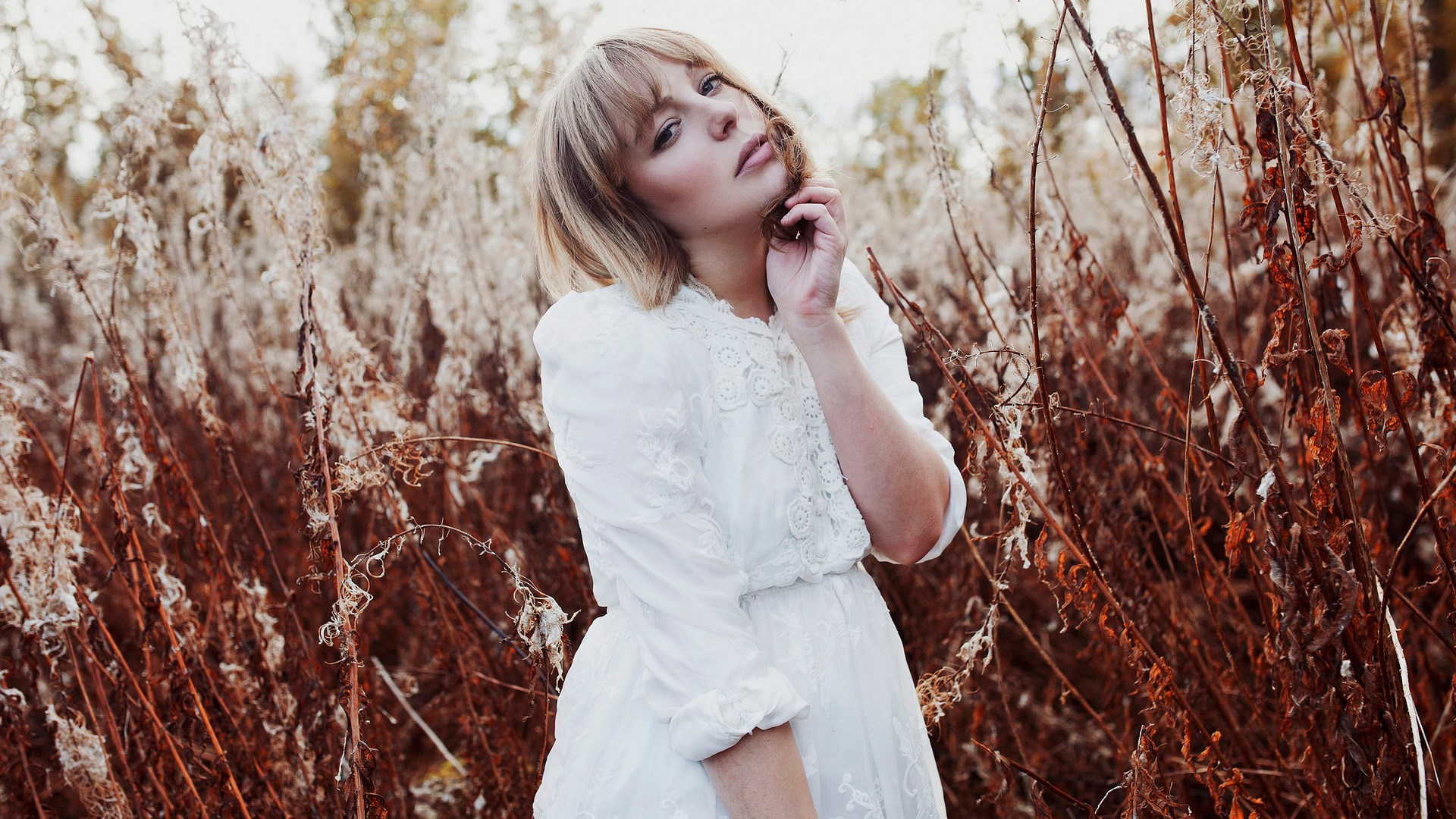 Woman in white dress in dry grass field HD Wallpaper
