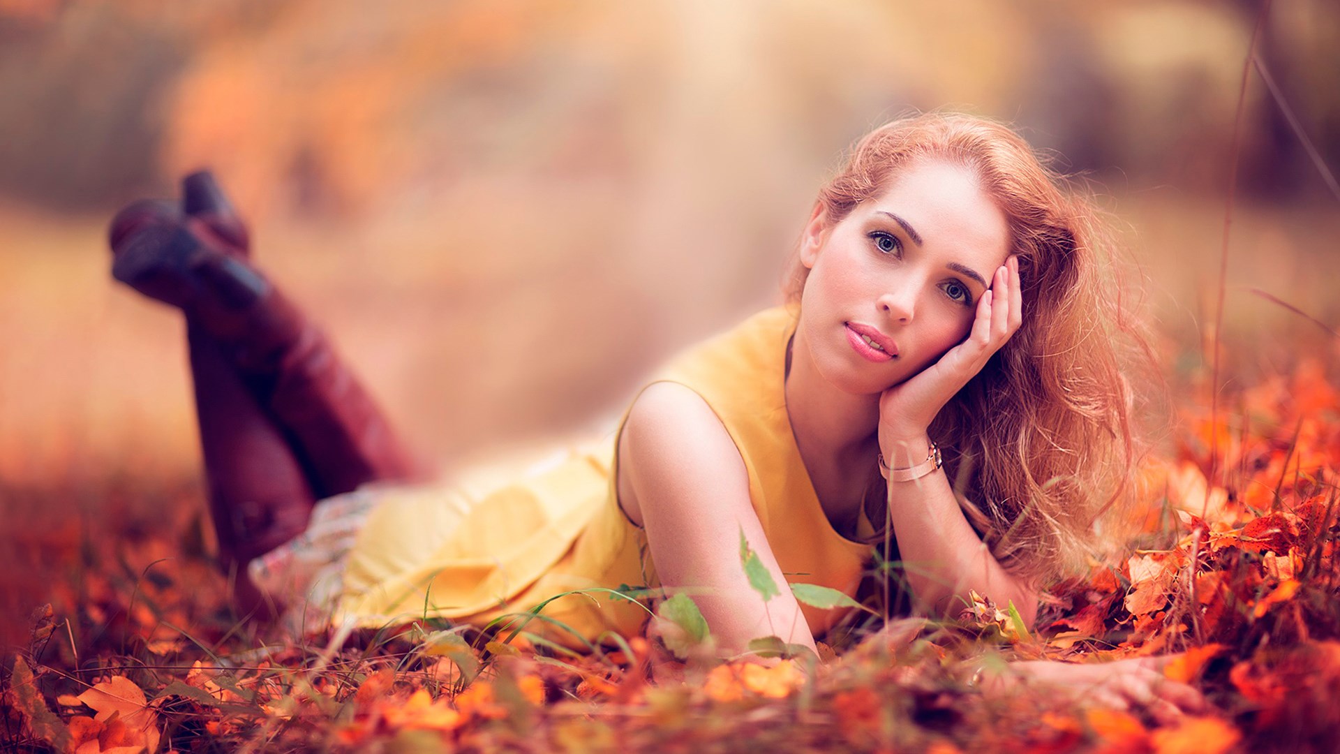 Woman lying in autumn leaves HD Wallpaper