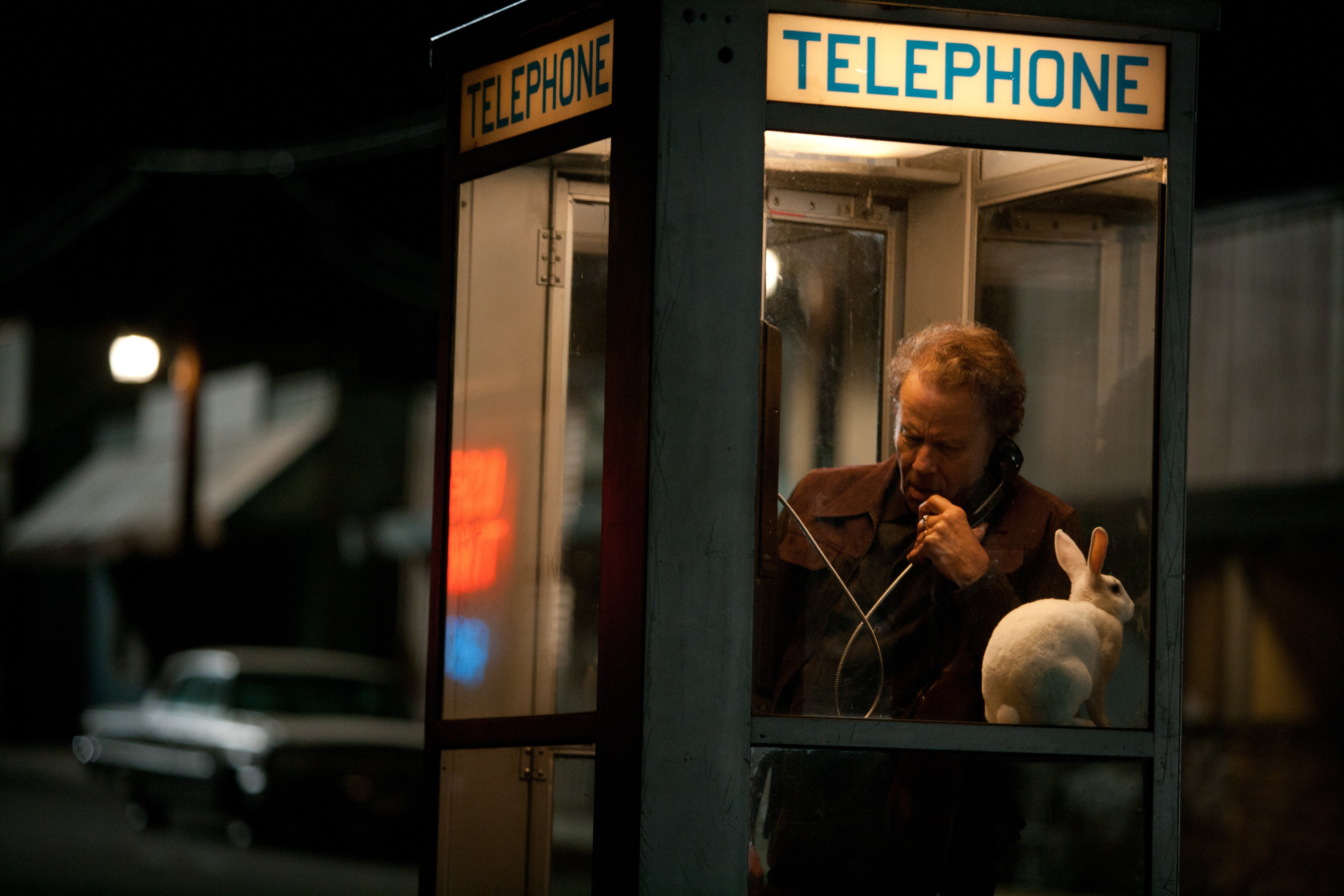 Tom Waits in a telephone booth with a rabbit HD Wallpaper