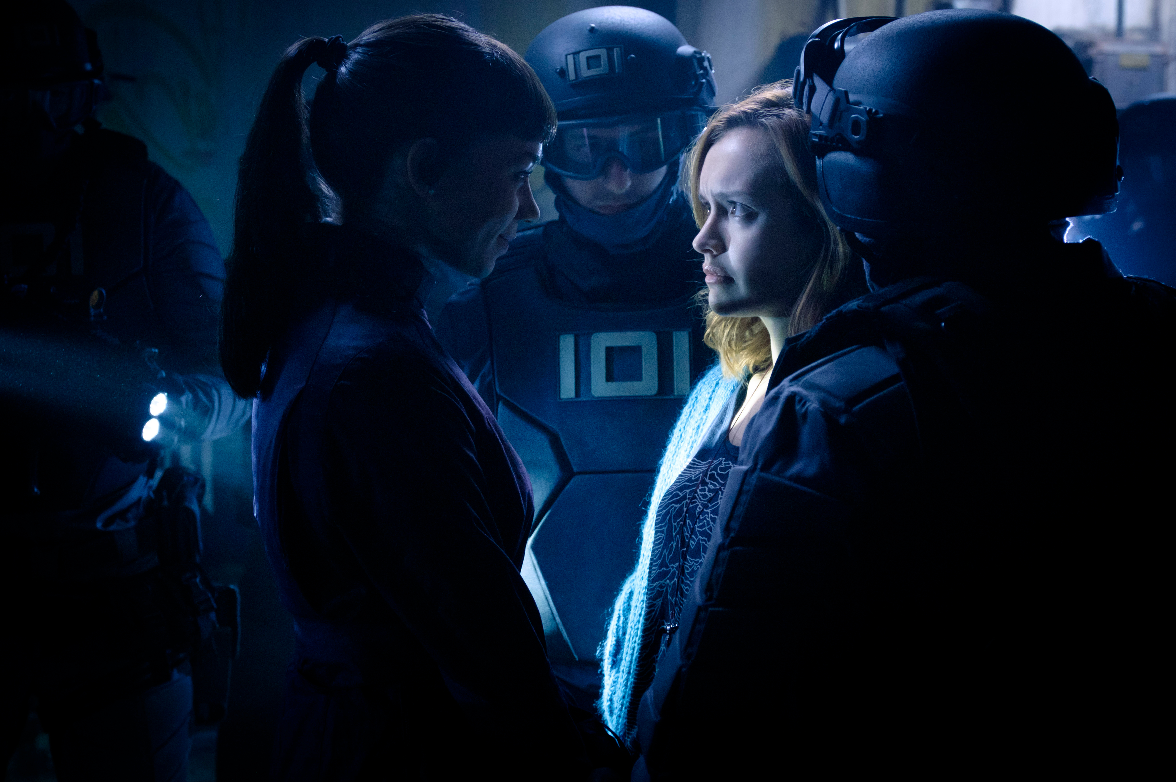 Hannah John-Kamen in a dark, futuristic setting HD Wallpaper