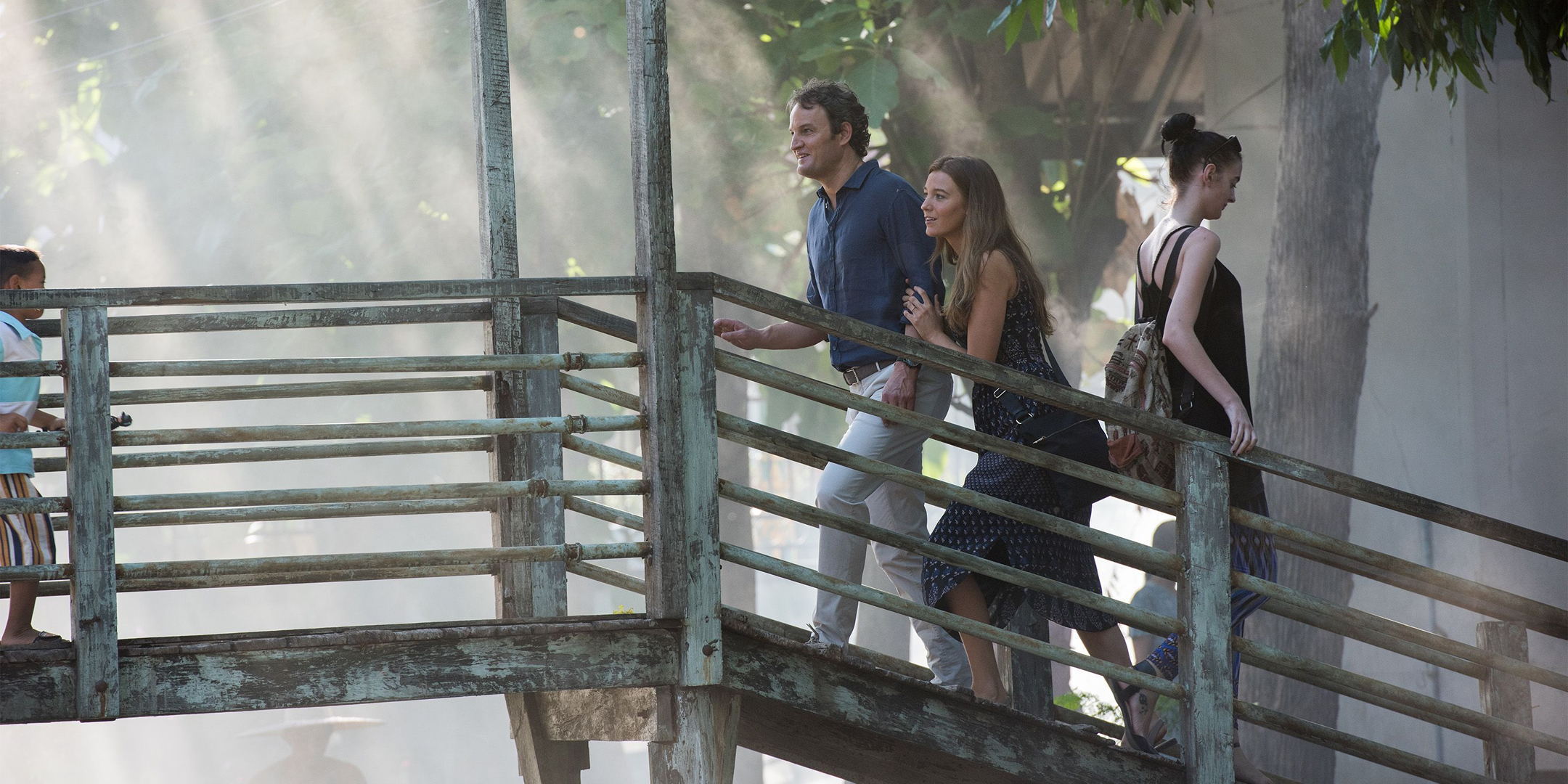 Jason Clarke and companions on a wooden bridge HD Wallpaper