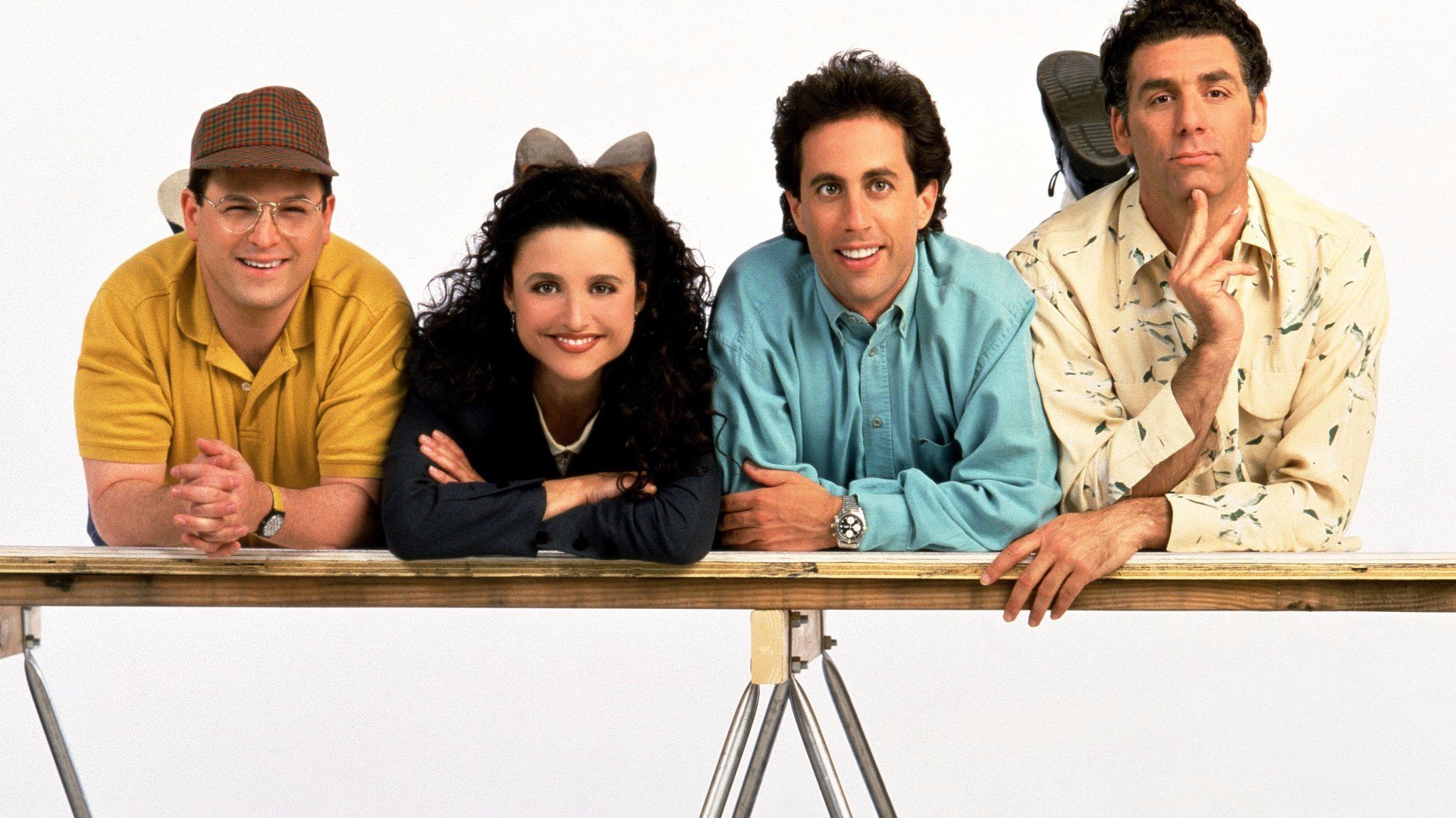 Seinfeld cast posing on a table HD Wallpaper