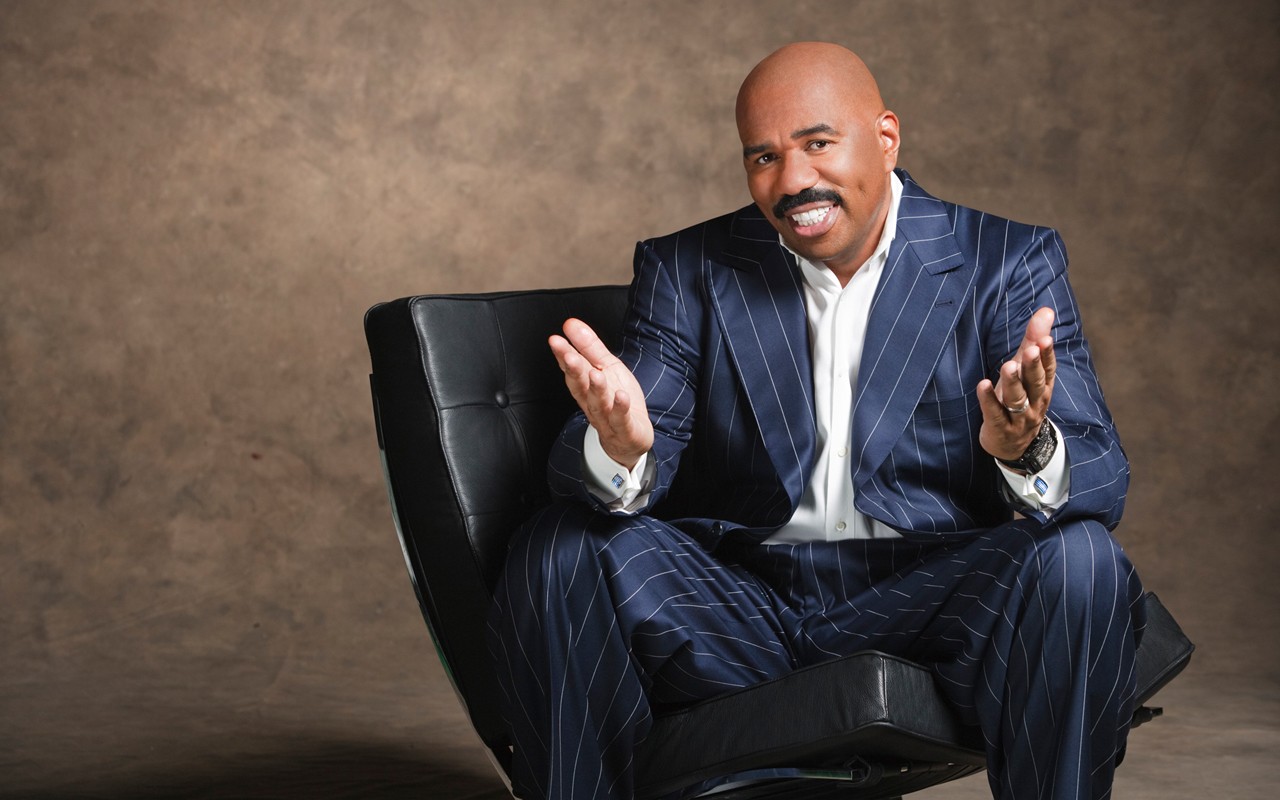 Steve Harvey sitting in a chair HD Wallpaper