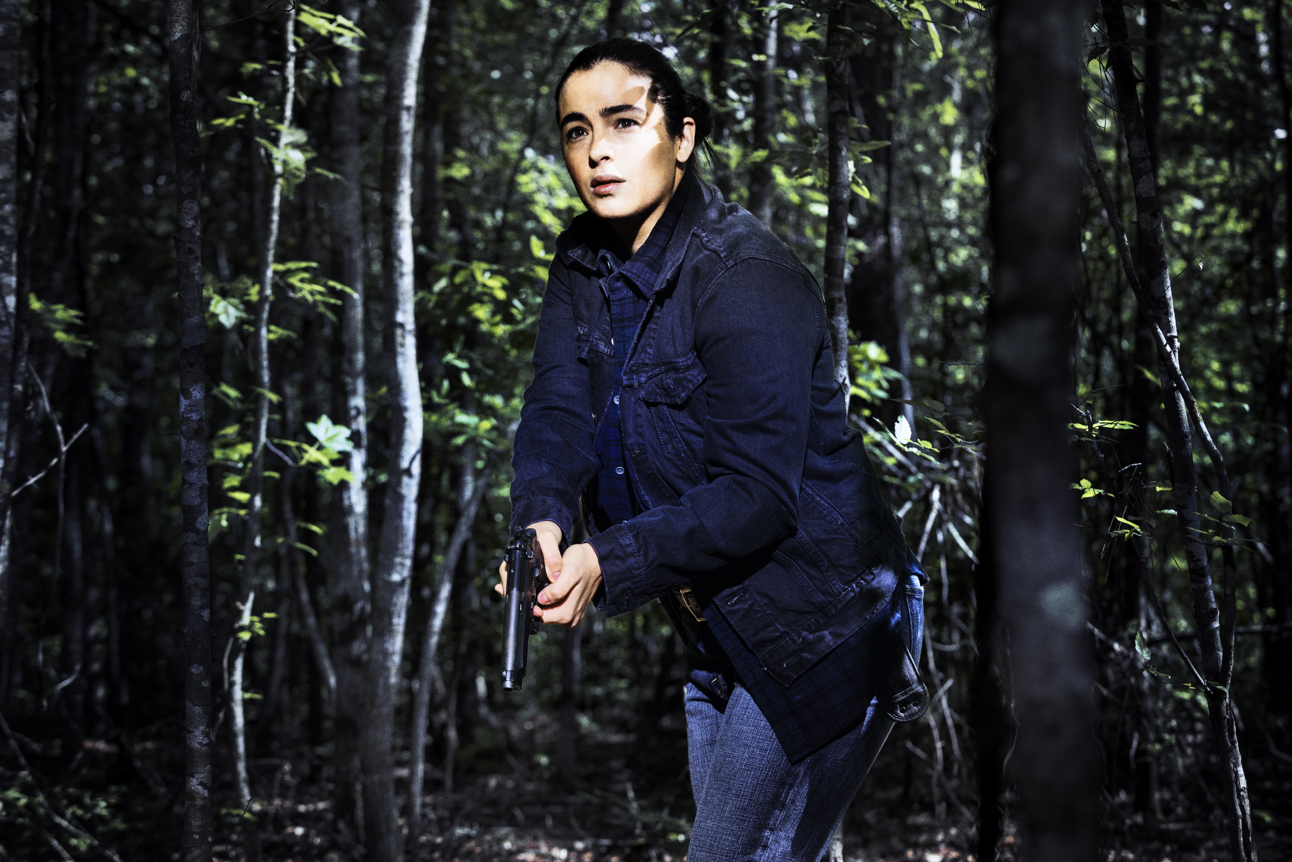 Alanna Masterson holding a gun in a forest HD Wallpaper