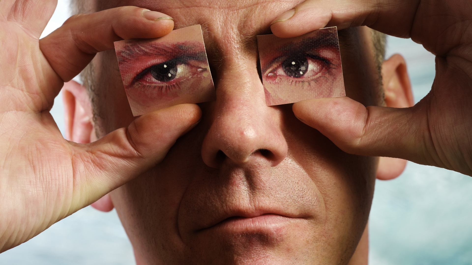 Fatboy Slim holding pictures of eyes over his eyes HD Wallpaper