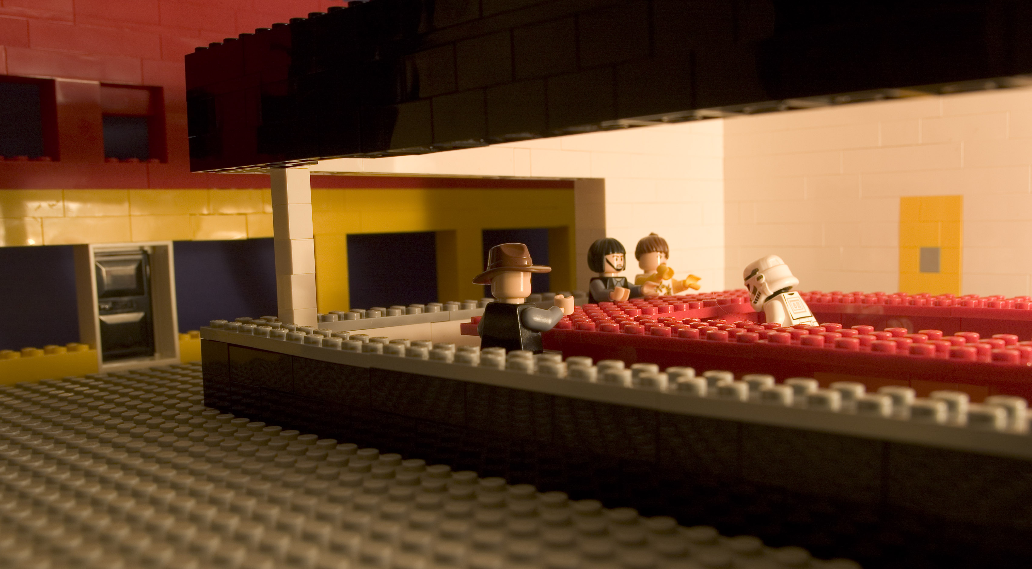 Lego figures in a red seating area HD Wallpaper