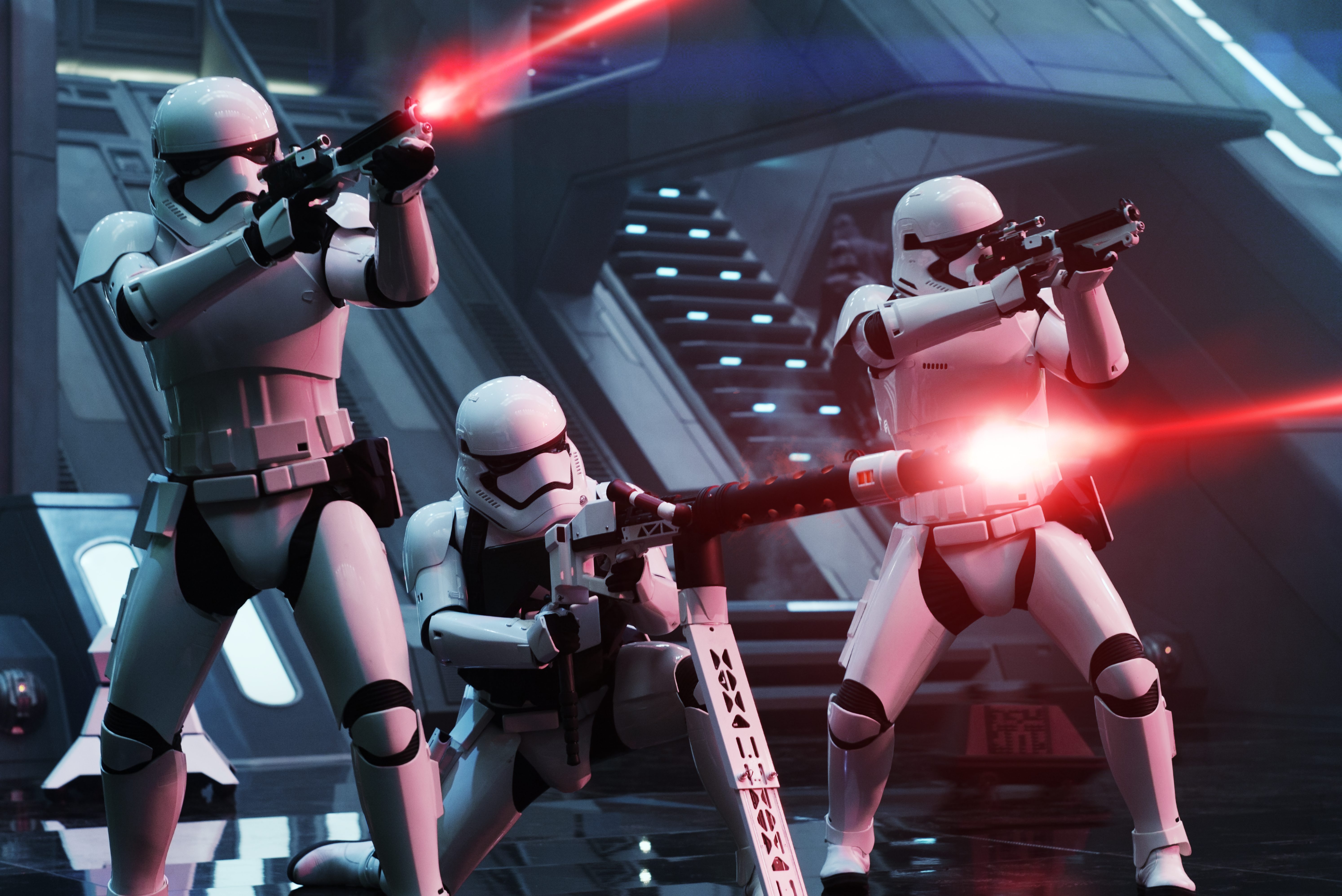 Stormtroopers firing blasters in a futuristic interior HD Wallpaper