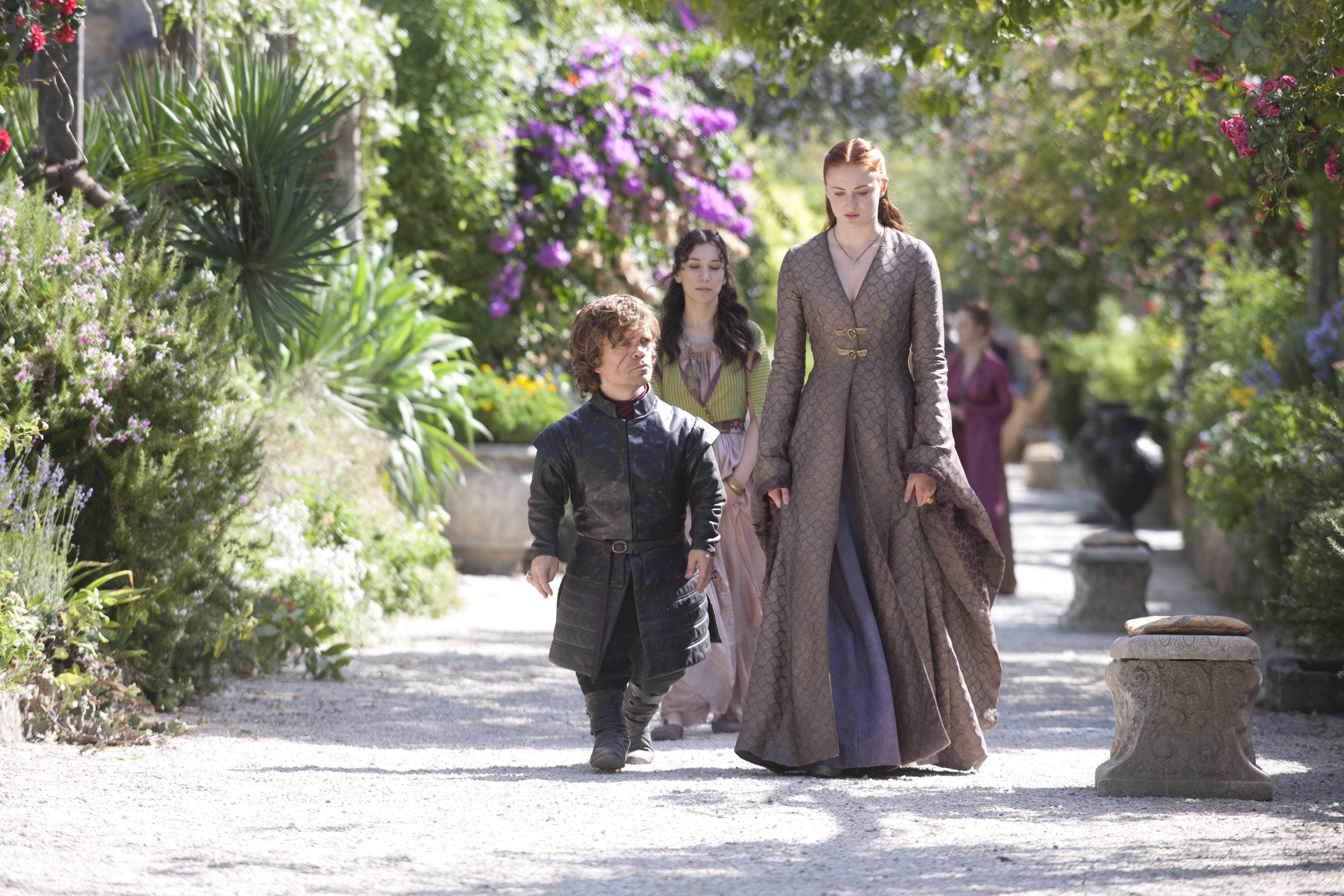 Tyrion Lannister and companions in a garden HD Wallpaper