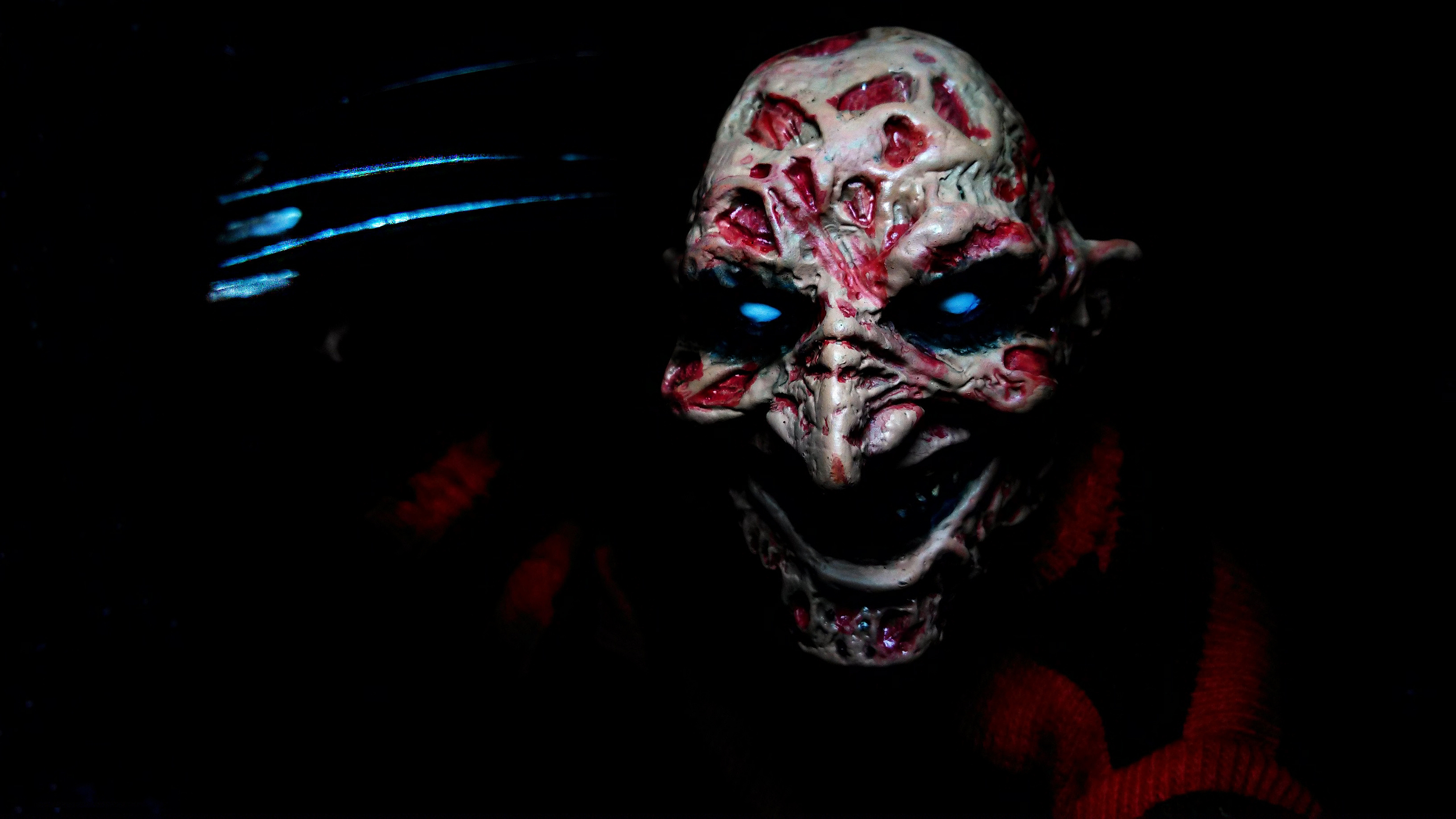 Freddy Krueger mask with glowing blue eyes HD Wallpaper
