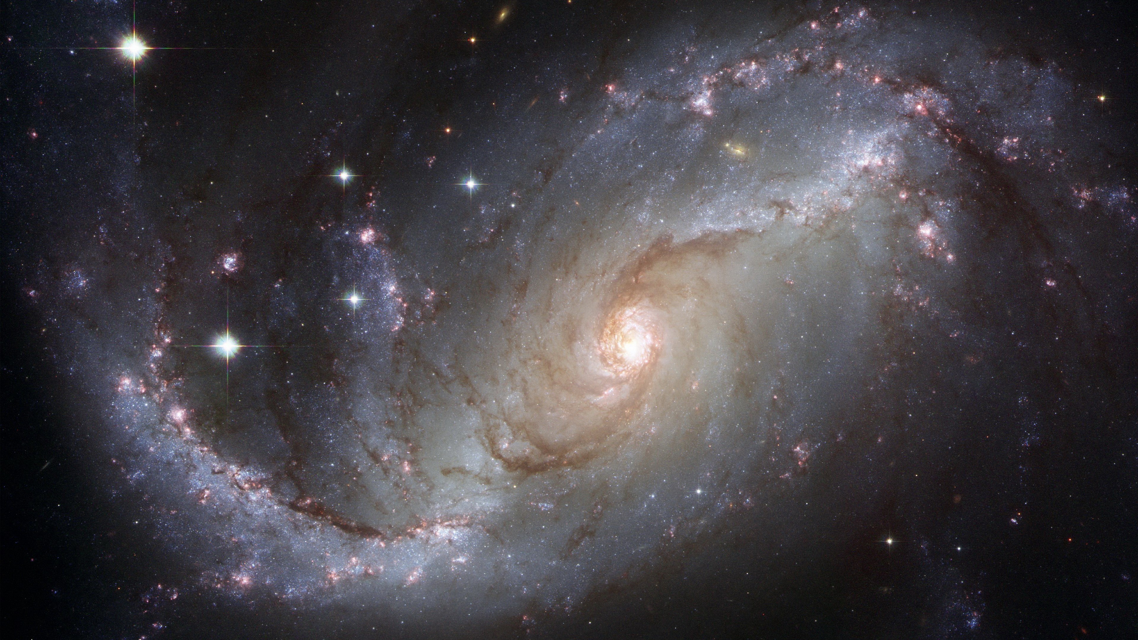 Barred spiral galaxy with bright core and arms HD Wallpaper