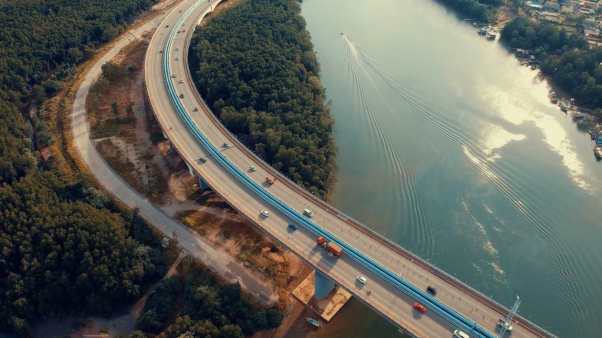 Aerial view of a bridge over a river with traffic HD Wallpaper