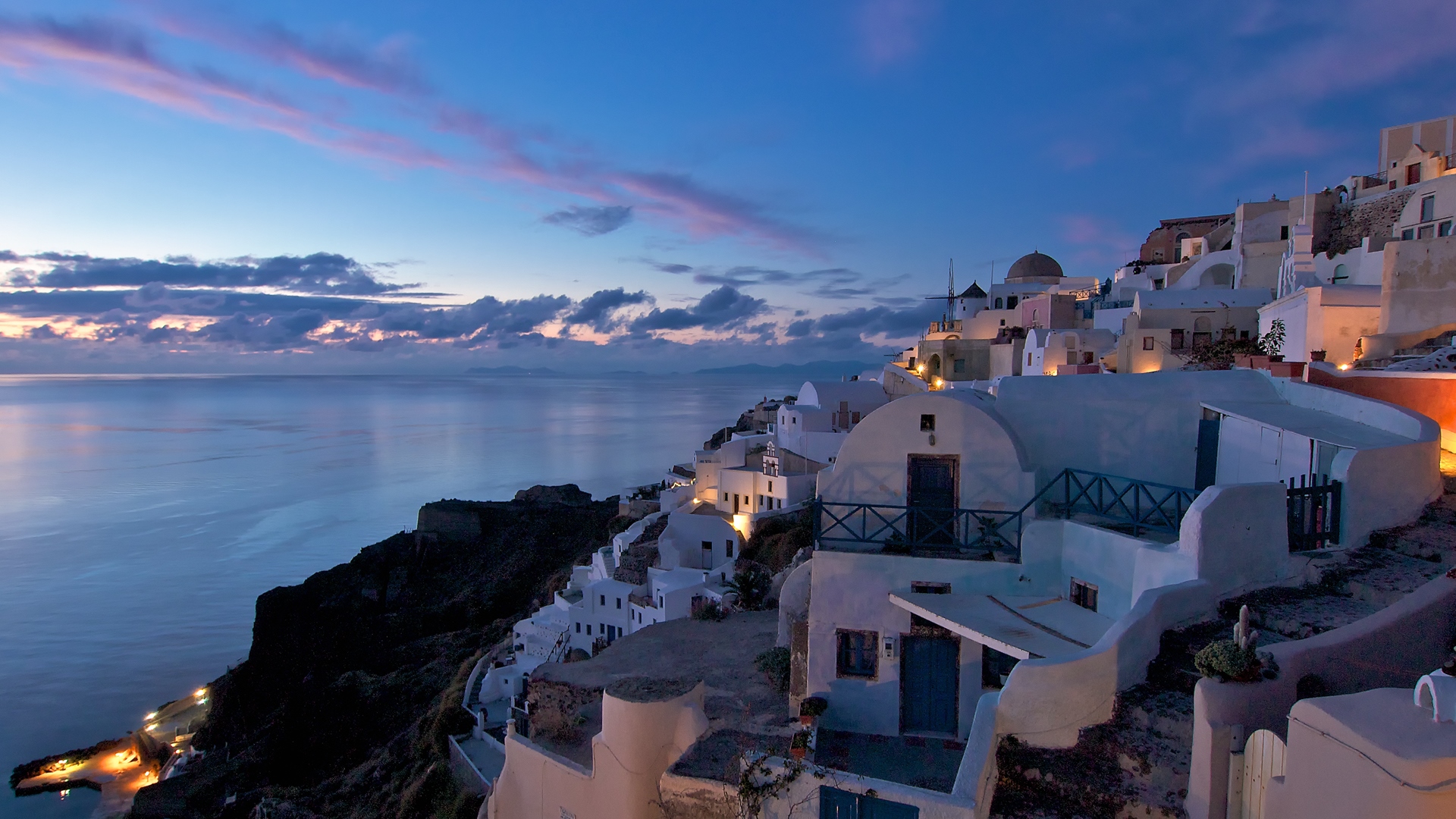 Santorini island at dusk with white houses overlooking the sea HD Wallpaper
