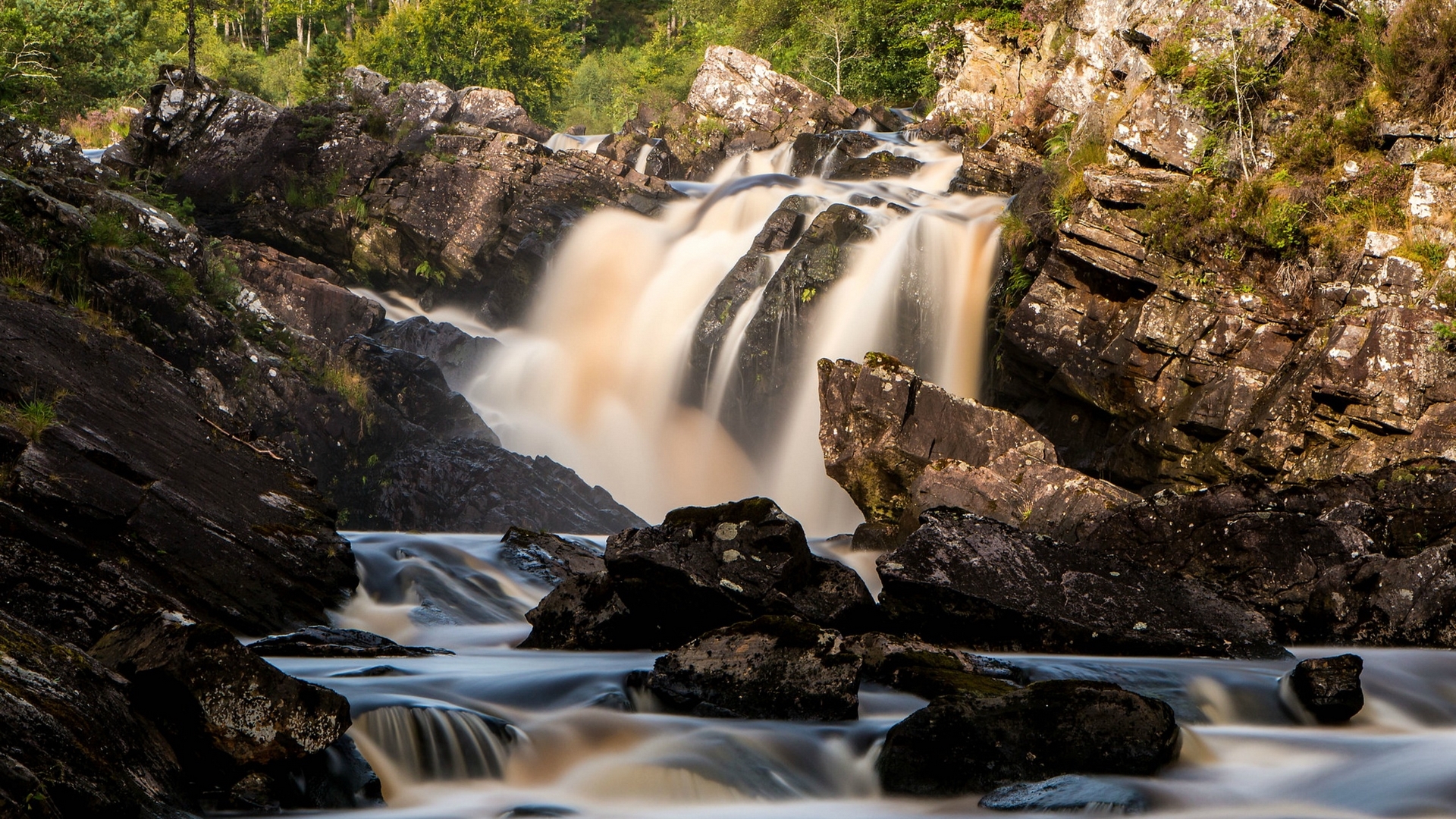 Waterfall cascading over rocks in Scotland HD Wallpaper