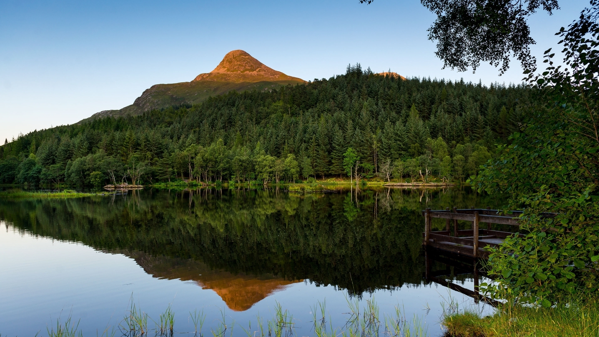 Mountain reflected in a lake with forest and pier HD Wallpaper