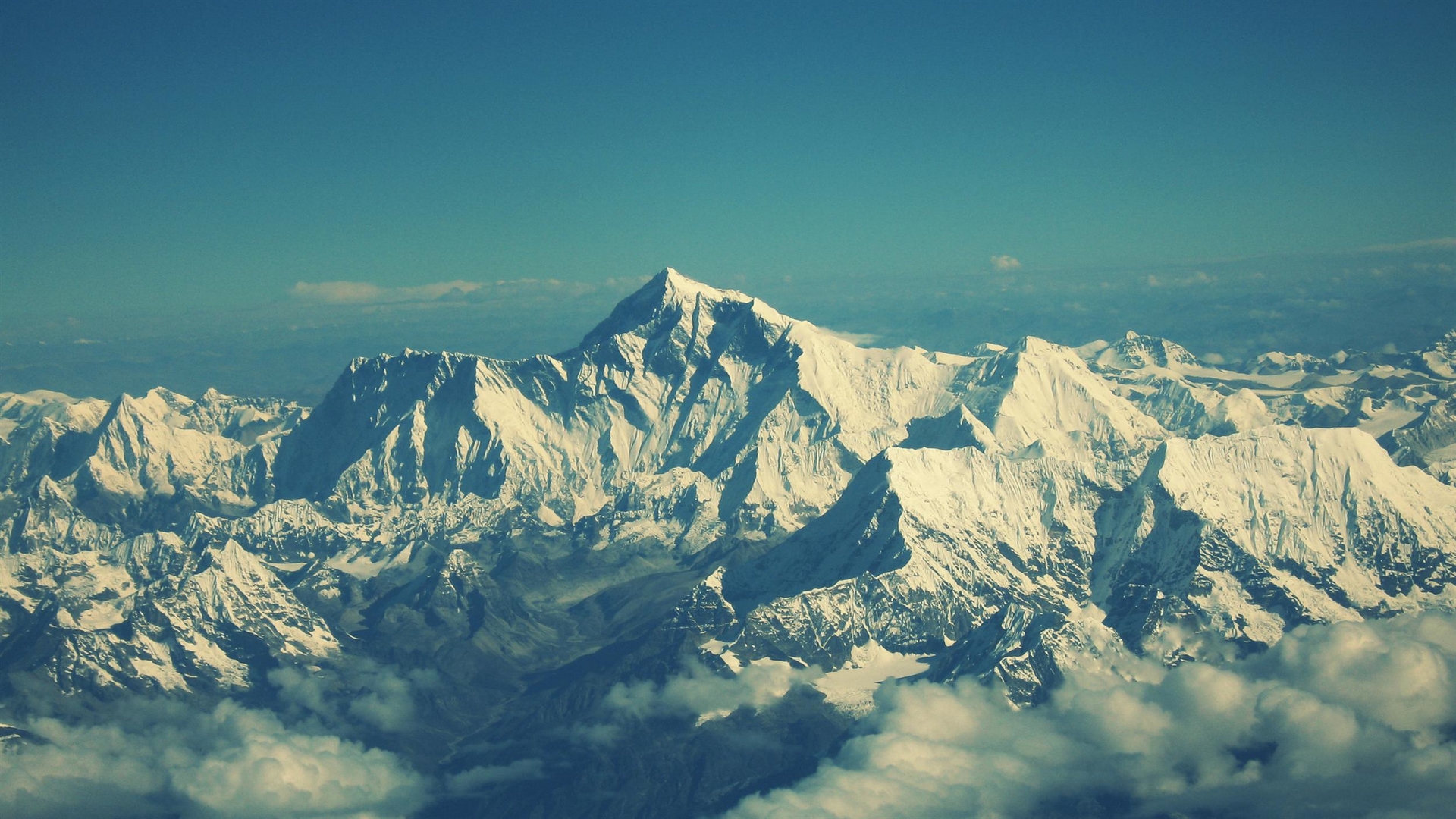 Snow-capped mountains under a clear blue sky HD Wallpaper