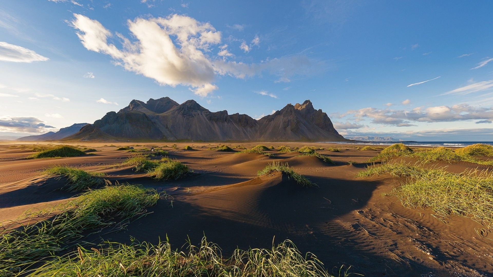 Black sand beach with mountains and clouds HD Wallpaper