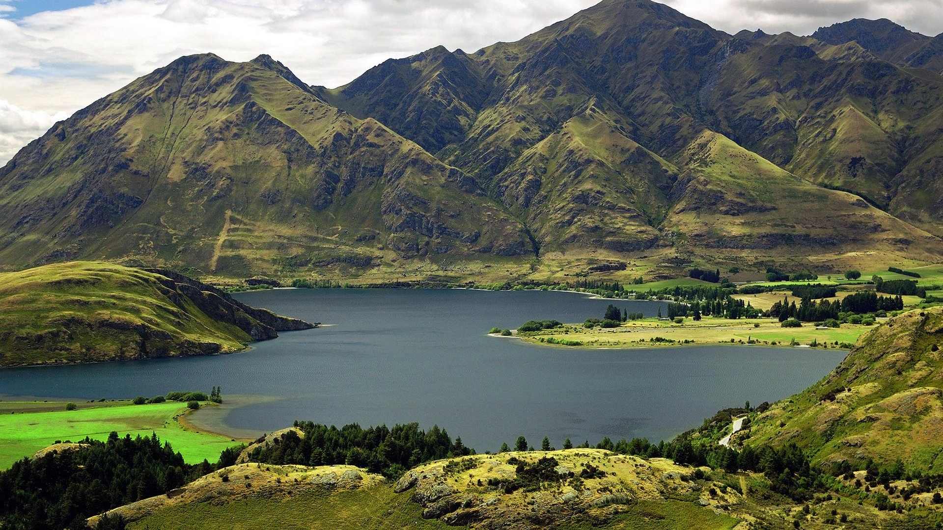 Mountains and lake landscape with green hills HD Wallpaper