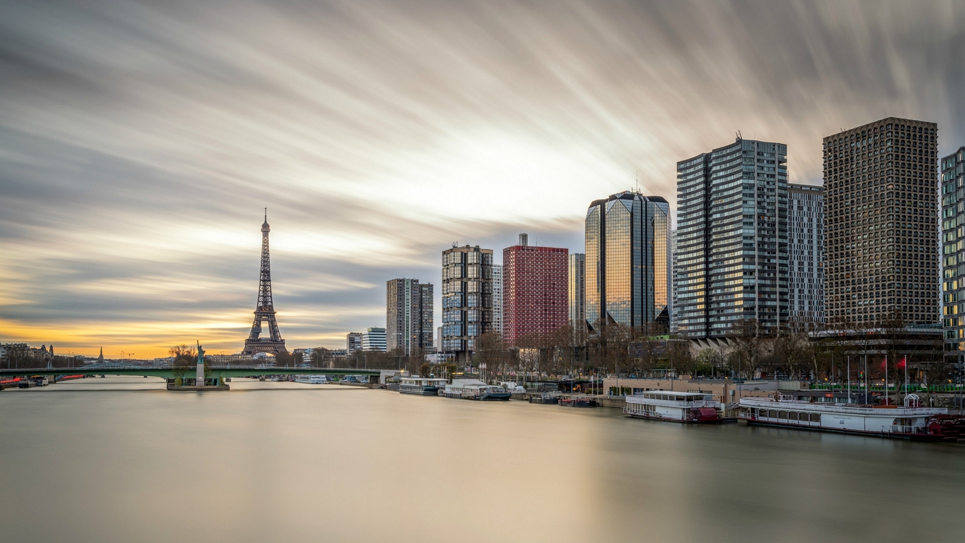 Paris skyline with Eiffel Tower and skyscrapers over the Seine River HD Wallpaper