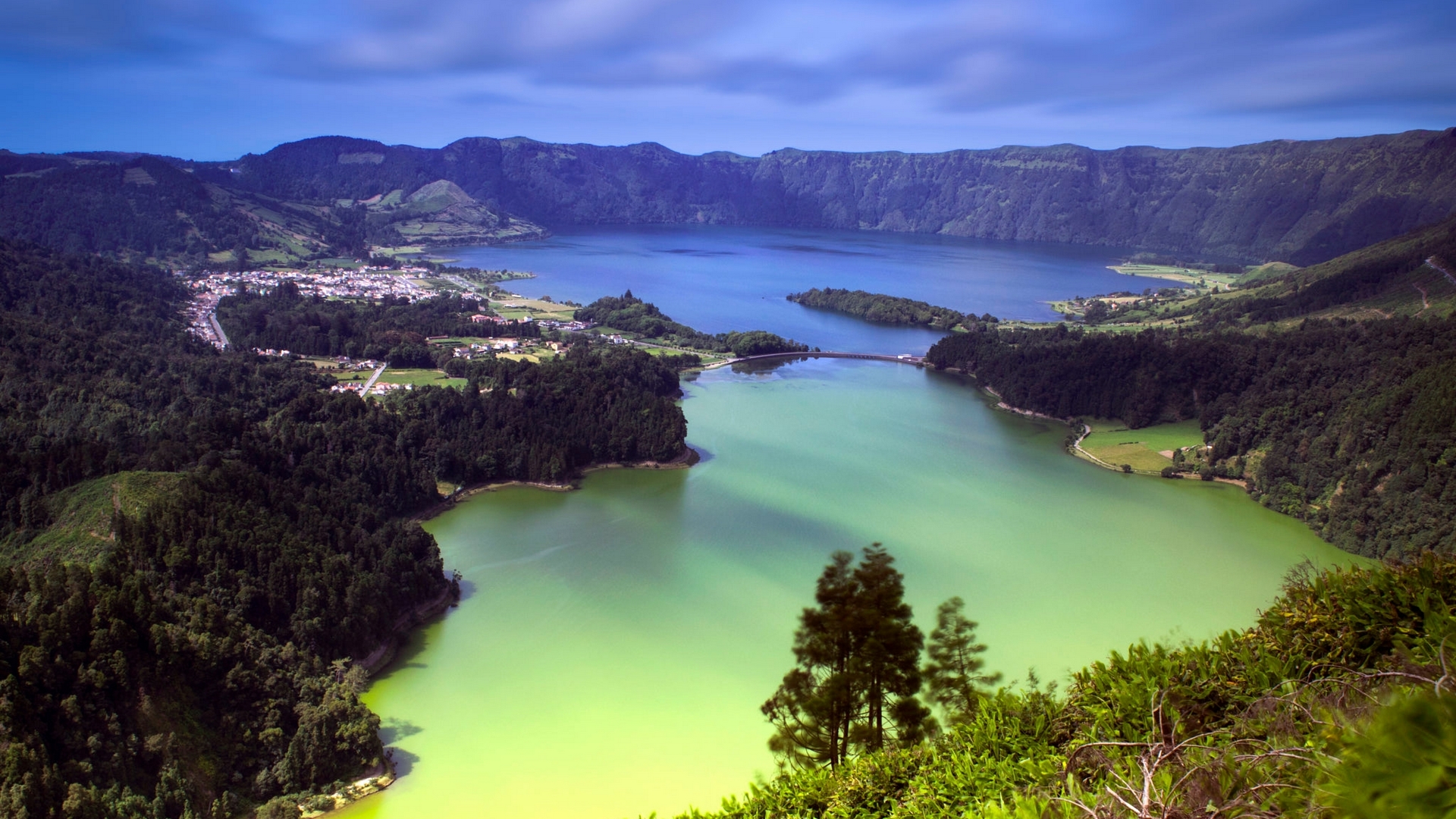 Volcanic lake with a town and bridge HD Wallpaper