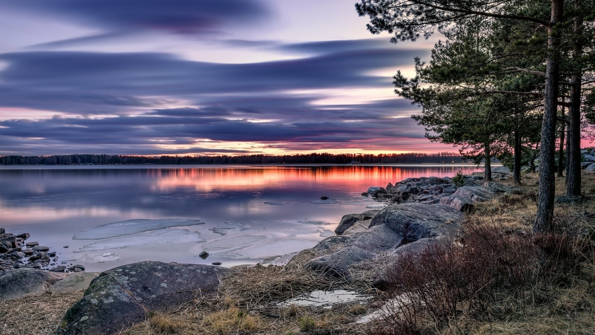 Sunset over a lake with trees and rocks HD Wallpaper