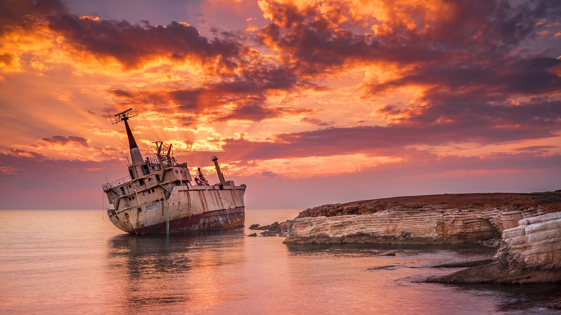 Shipwreck on the coast during sunset HD Wallpaper