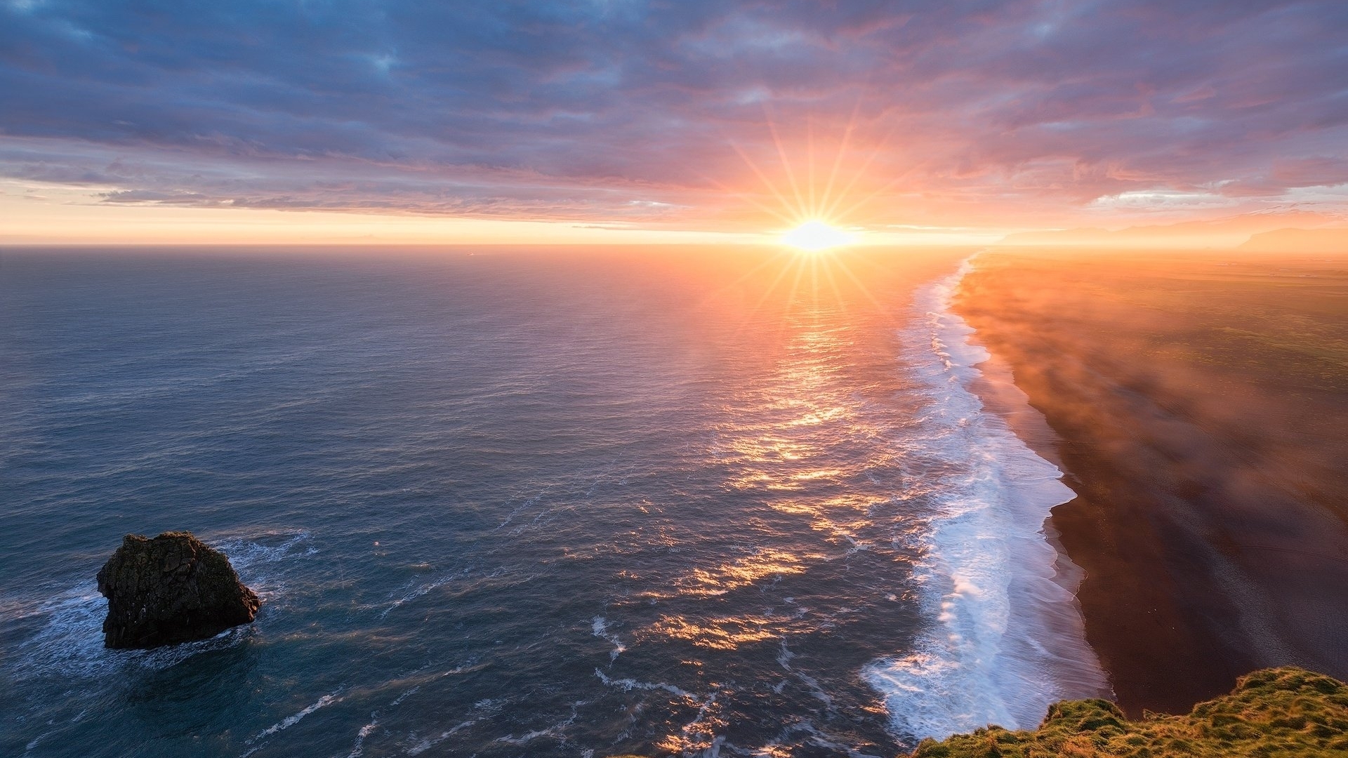 Sunrise over the ocean with a rocky shore HD Wallpaper