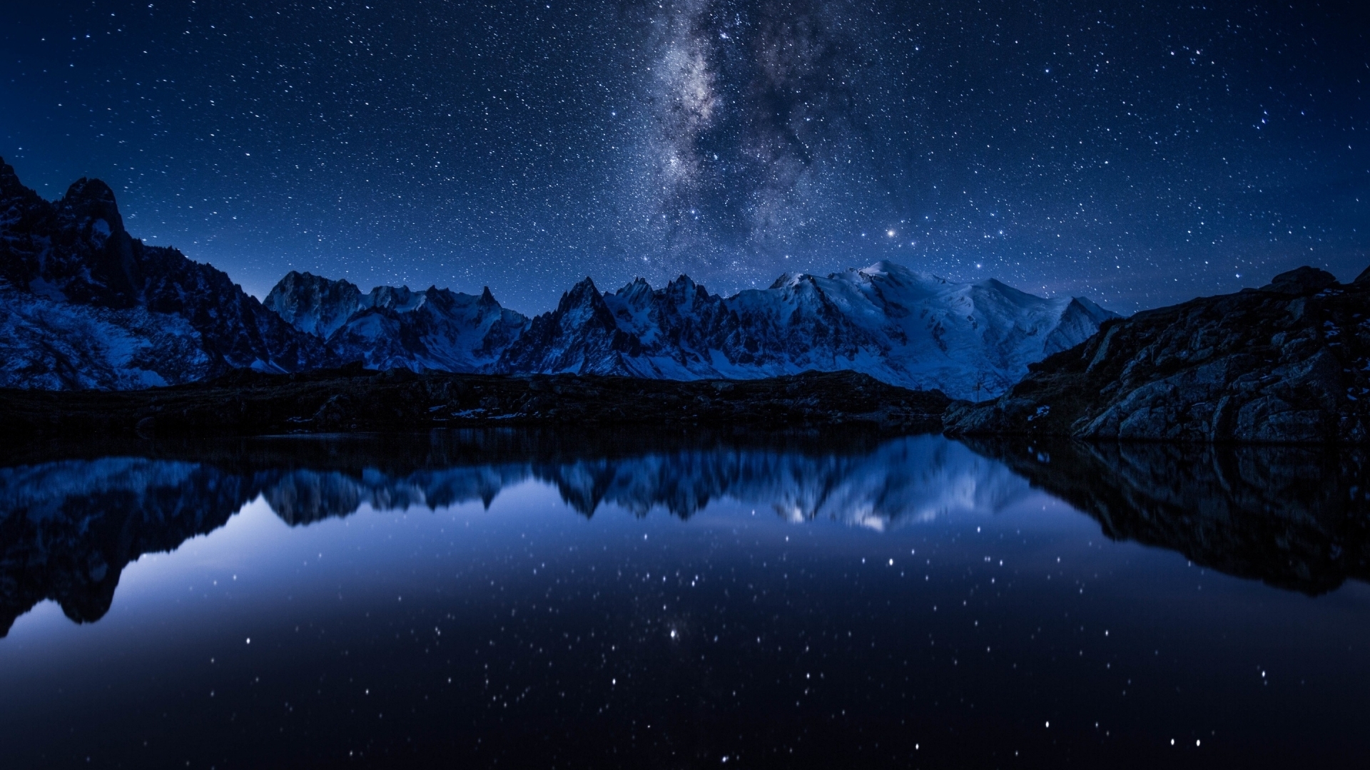Milky Way over snow-capped mountains reflected in a lake HD Wallpaper