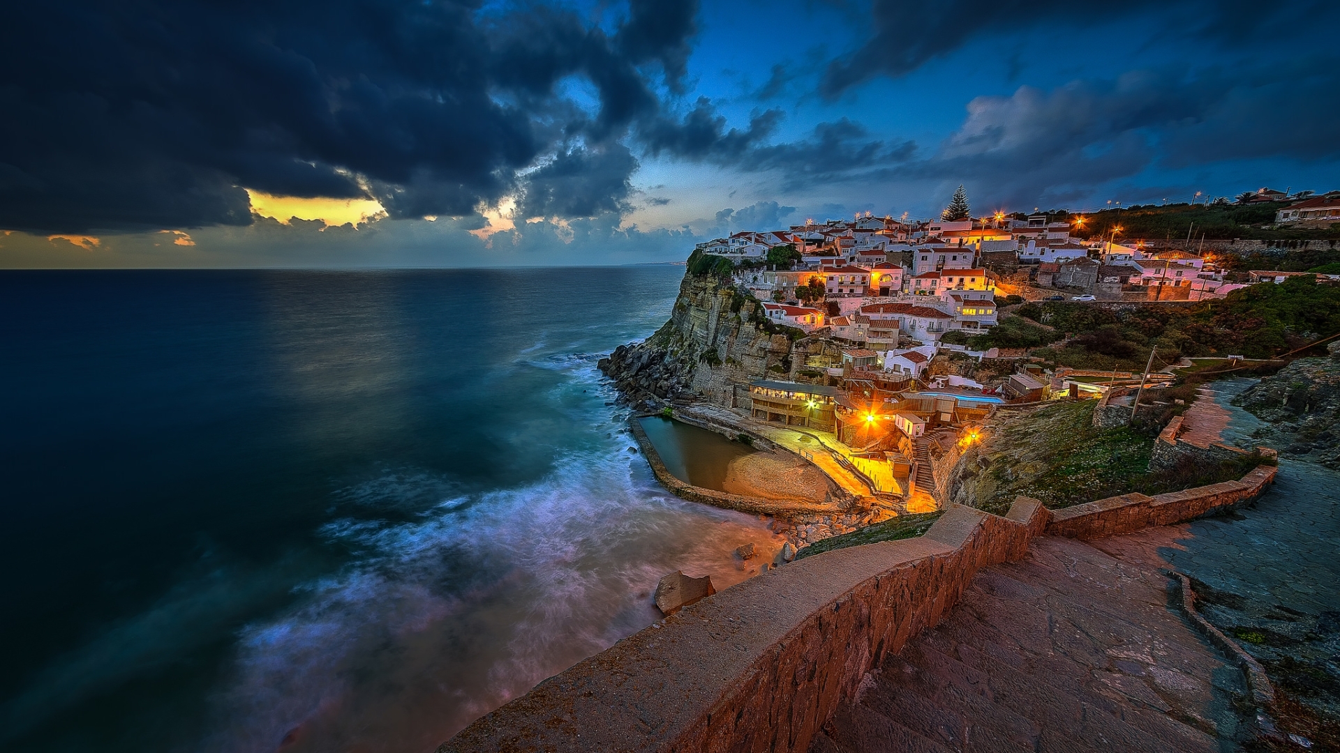 Coastal village on a cliffside at dusk HD Wallpaper