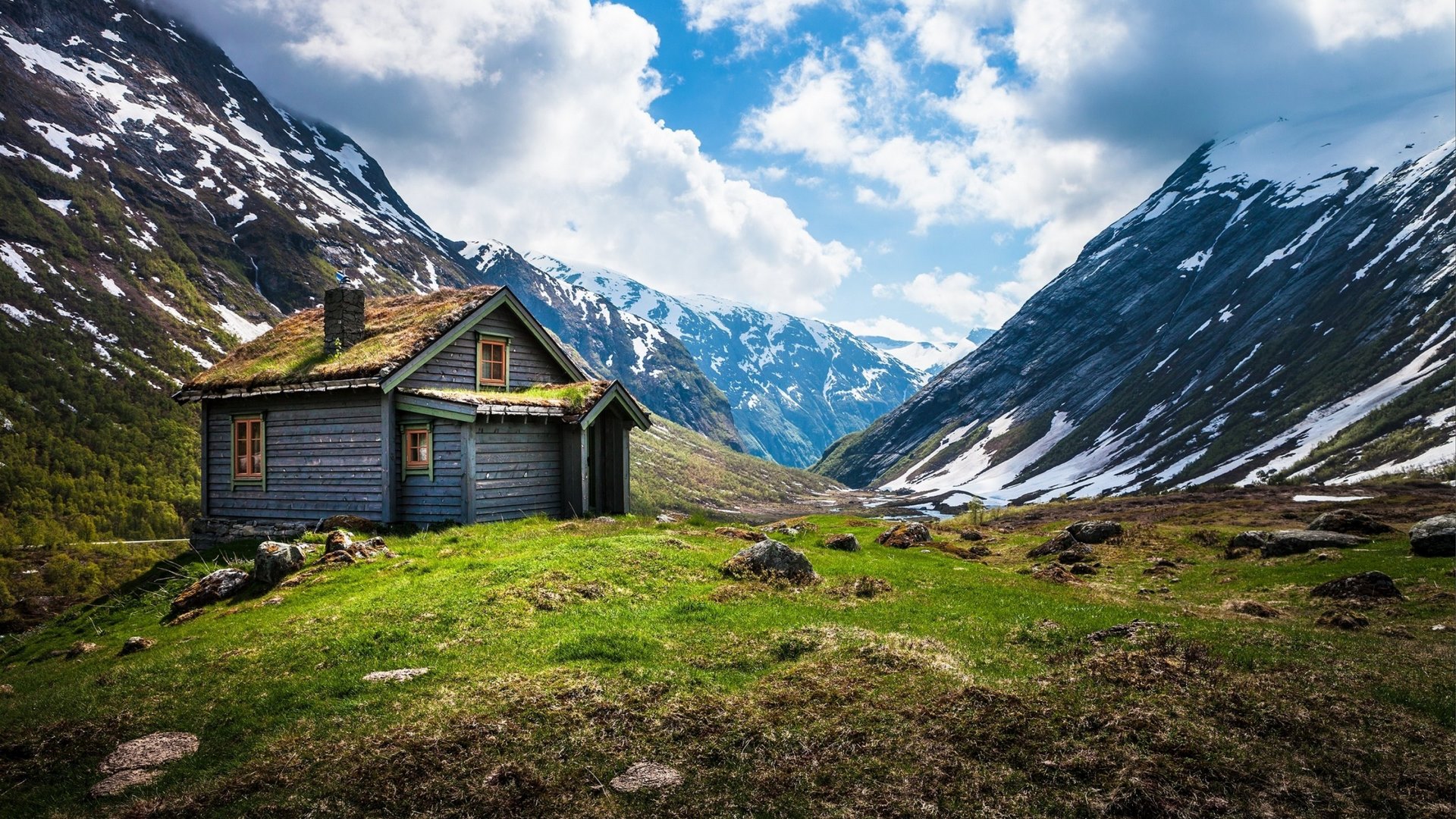 Wooden cabin with grass roof in snowy mountains HD Wallpaper