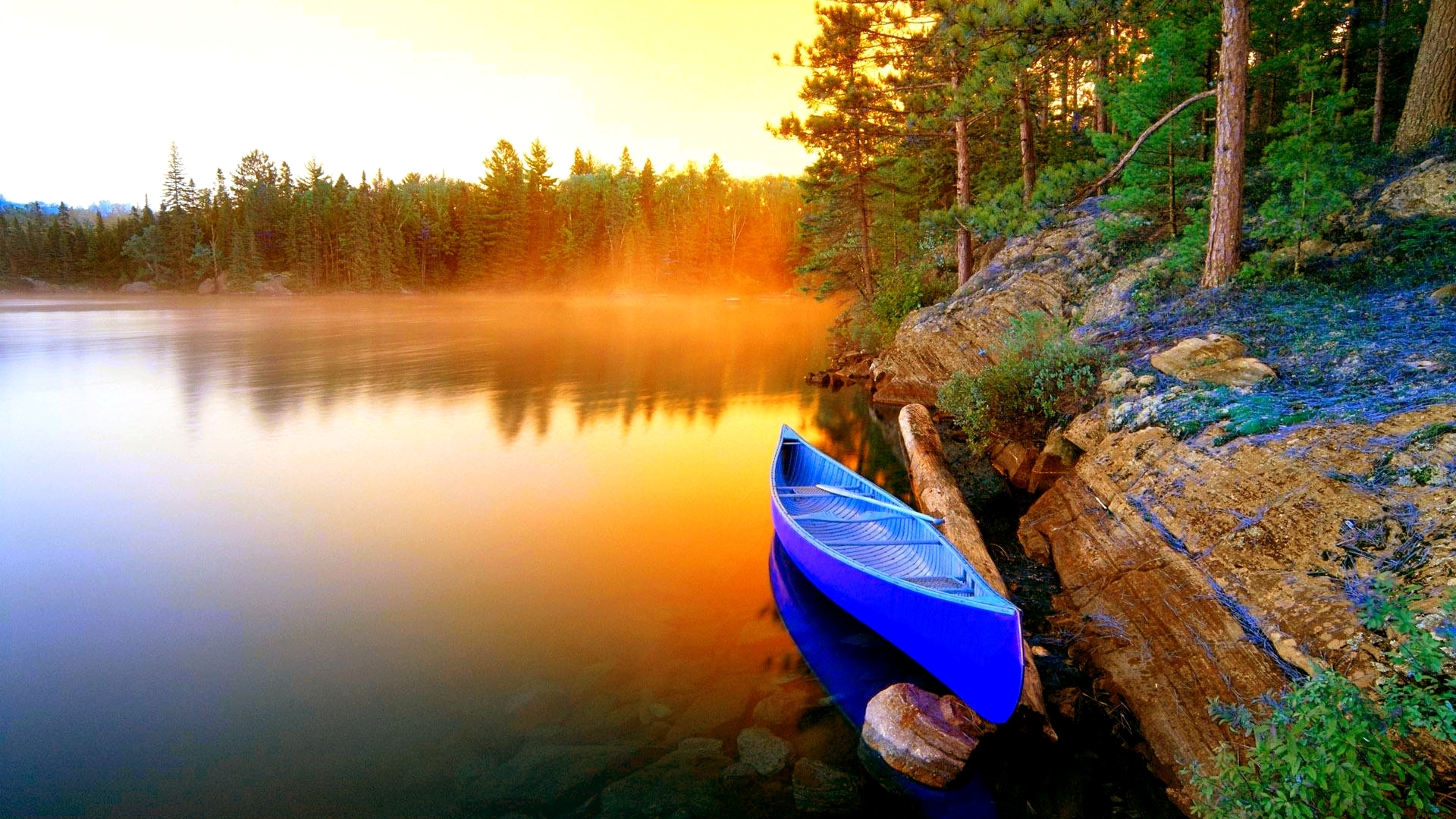 Blue canoe on a misty lake at sunset HD Wallpaper
