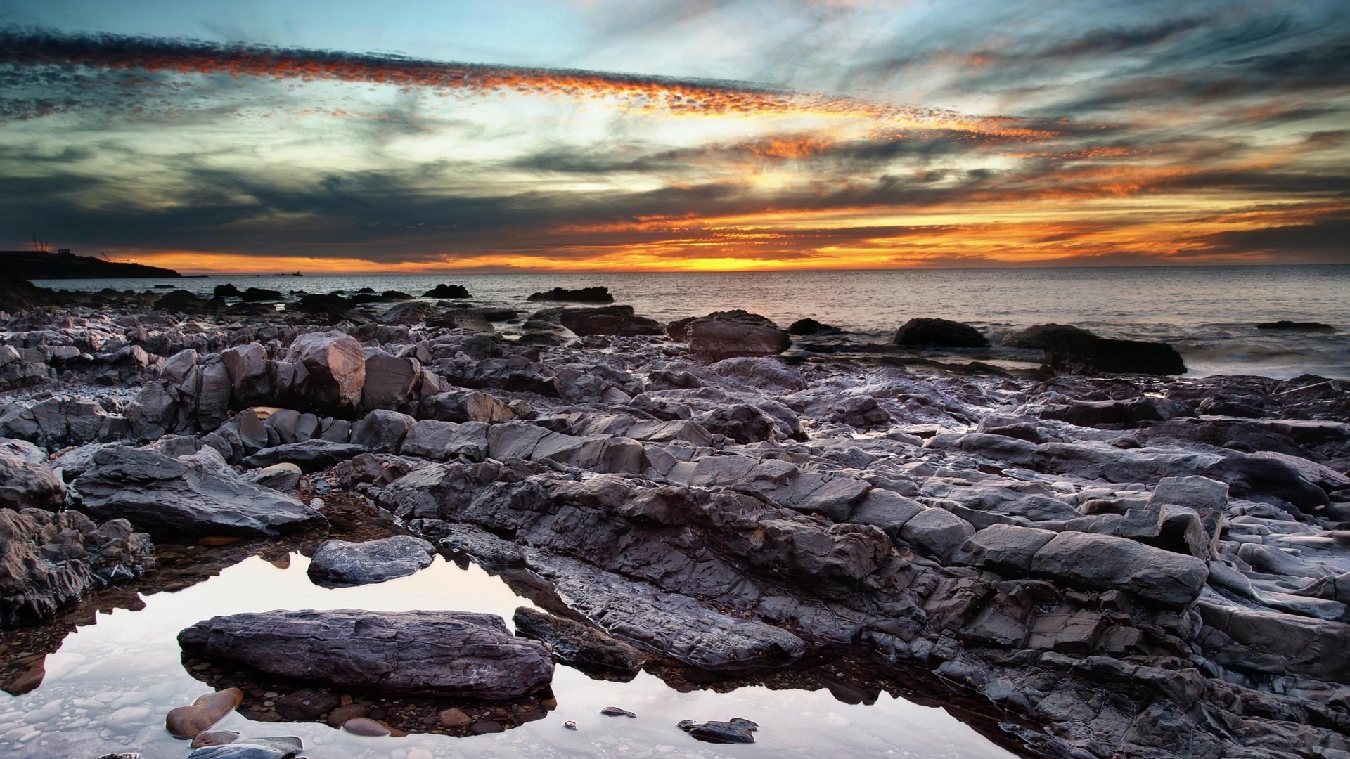 Rocky Shoreline at Sunset with Colorful Clouds HD Wallpaper