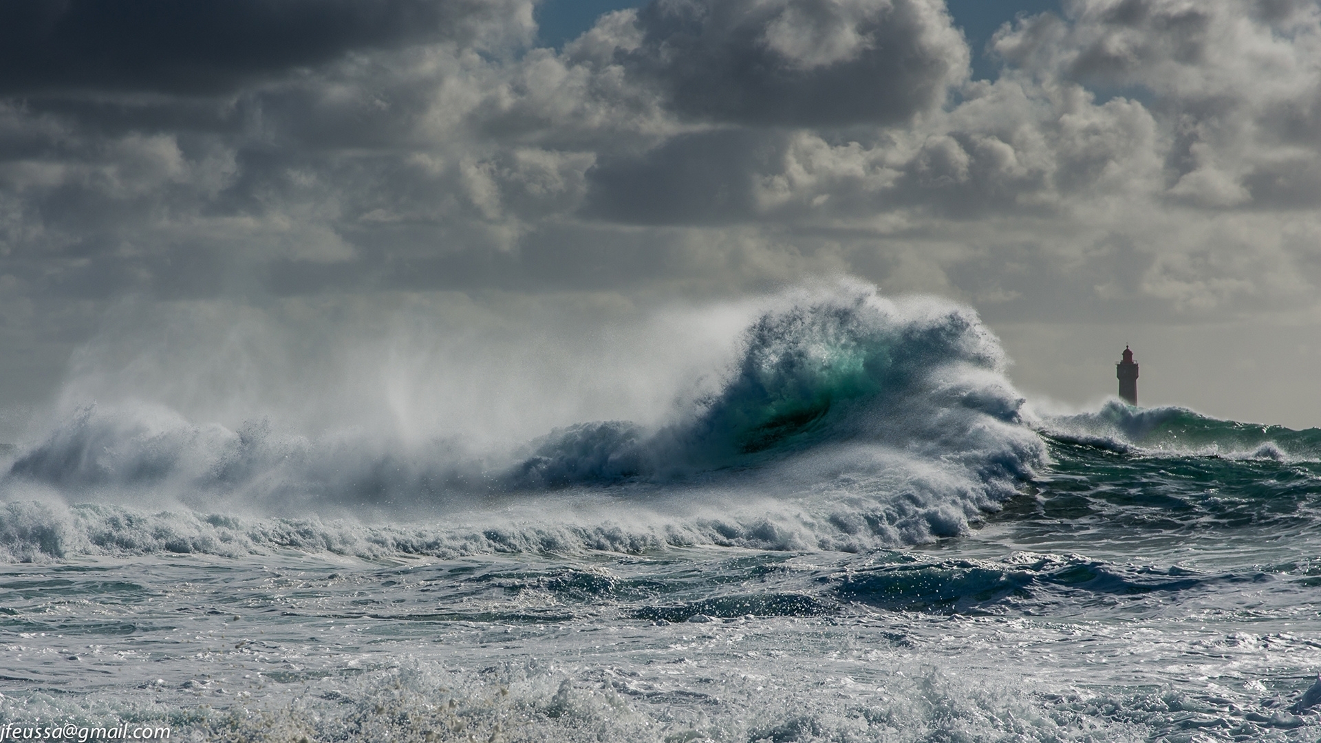 Stormy ocean with large waves and a lighthouse HD Wallpaper