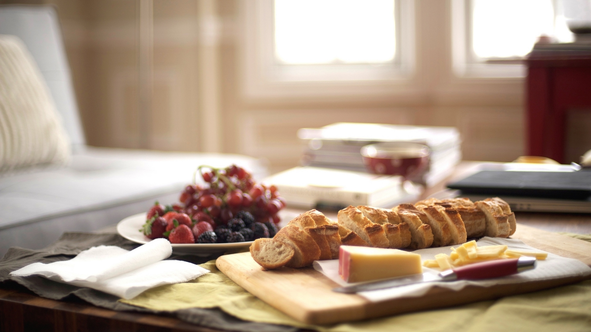 Bread, cheese, and fruit platter on a table HD Wallpaper