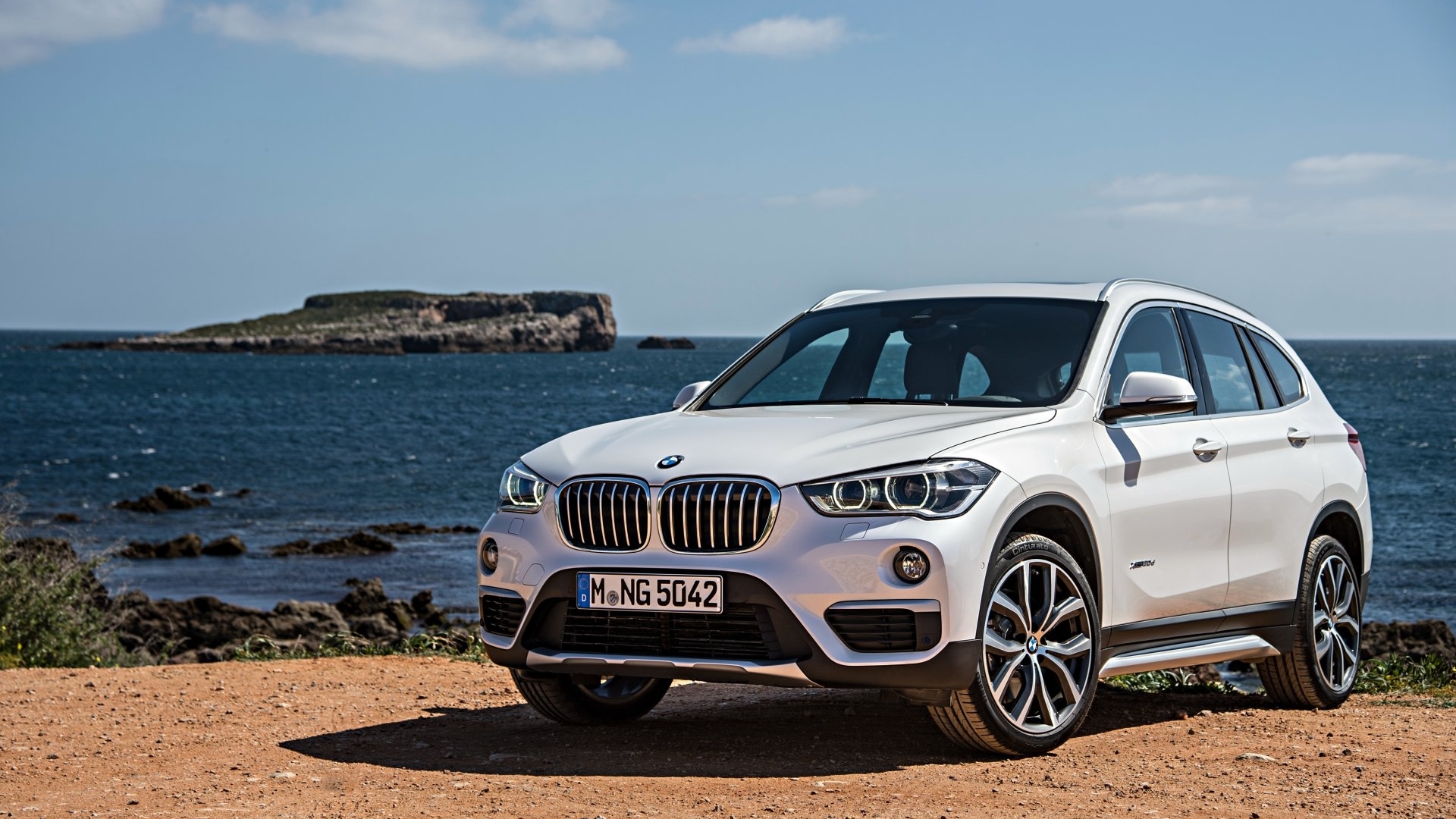 White BMW X1 parked by the sea HD Wallpaper
