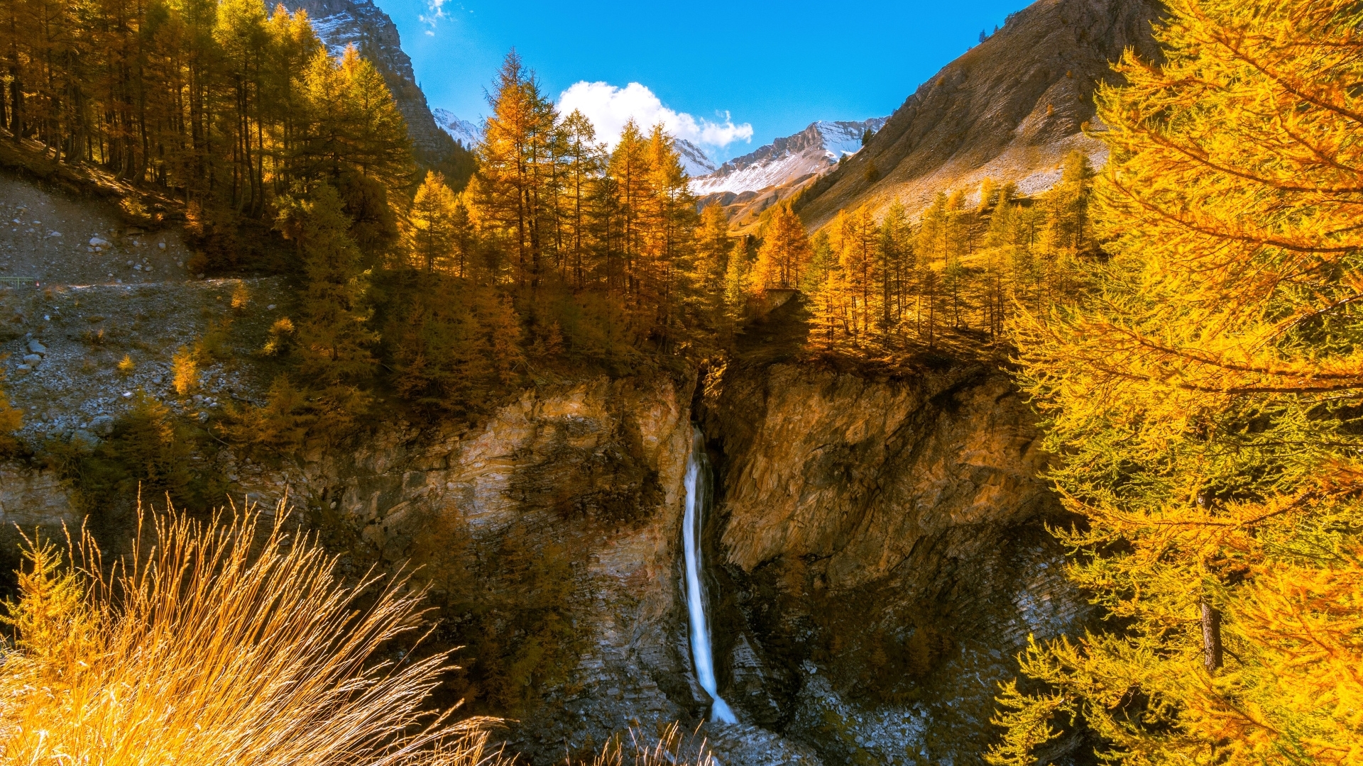 Waterfall in a mountain valley during autumn HD Wallpaper
