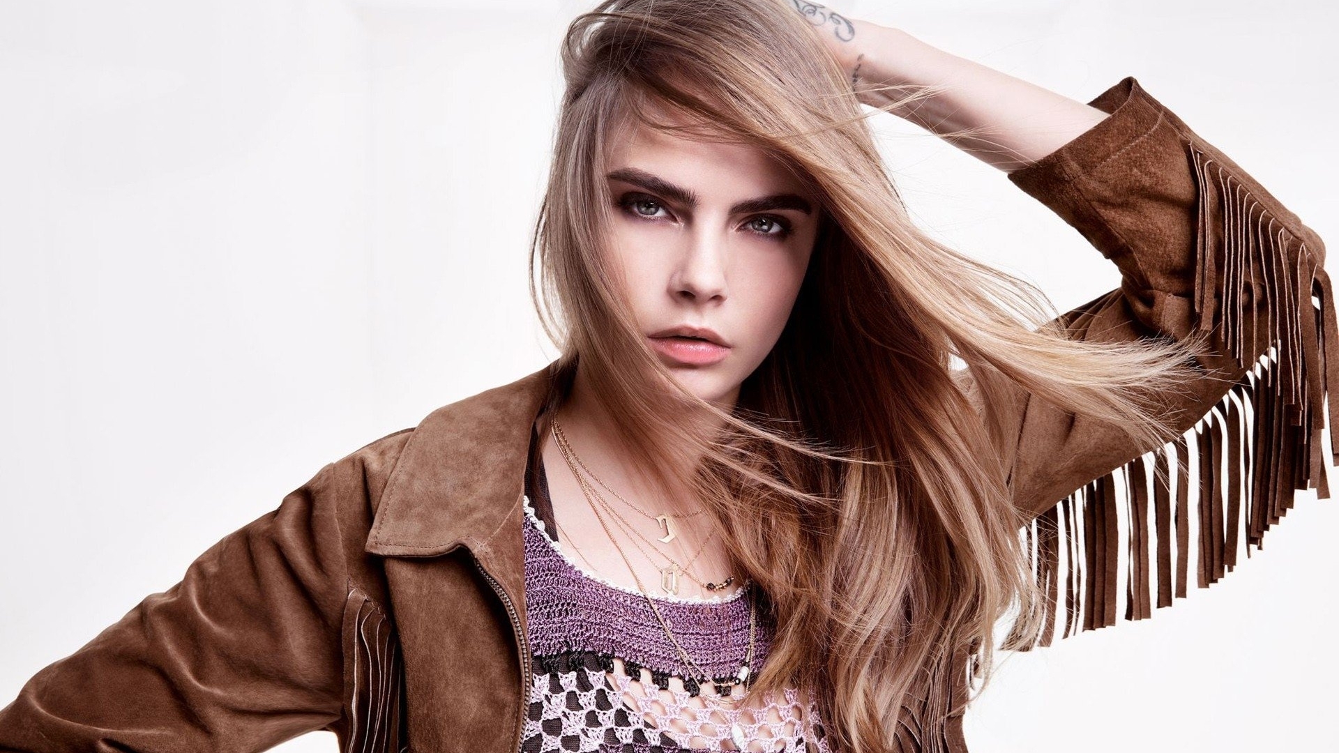 Cara Delevingne in a brown fringed jacket HD Wallpaper