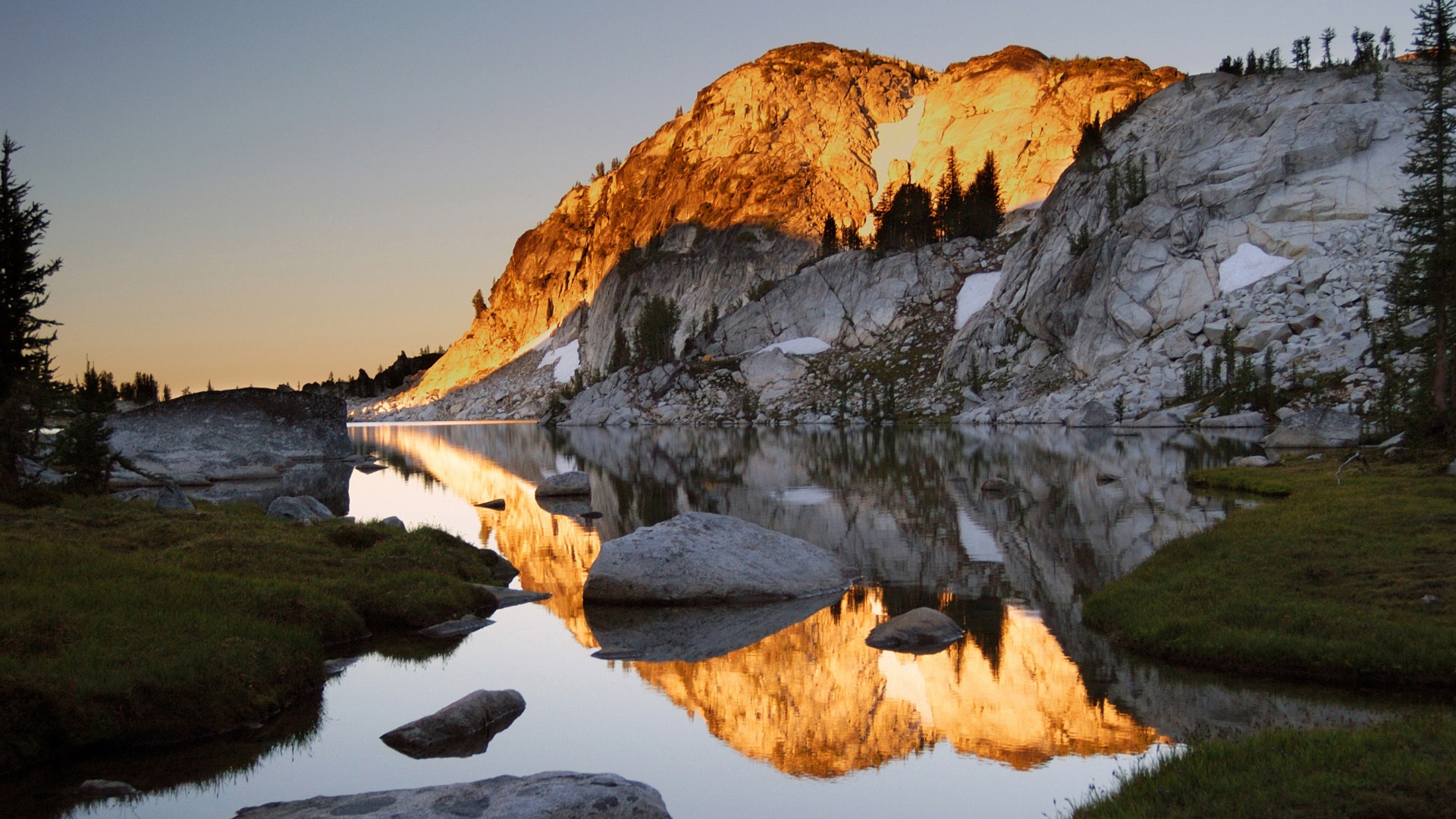 Mountain lake reflecting golden sunlight at sunset HD Wallpaper