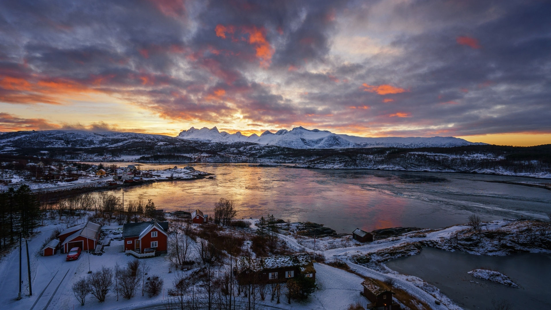 Snowy landscape with houses and mountains at sunset HD Wallpaper