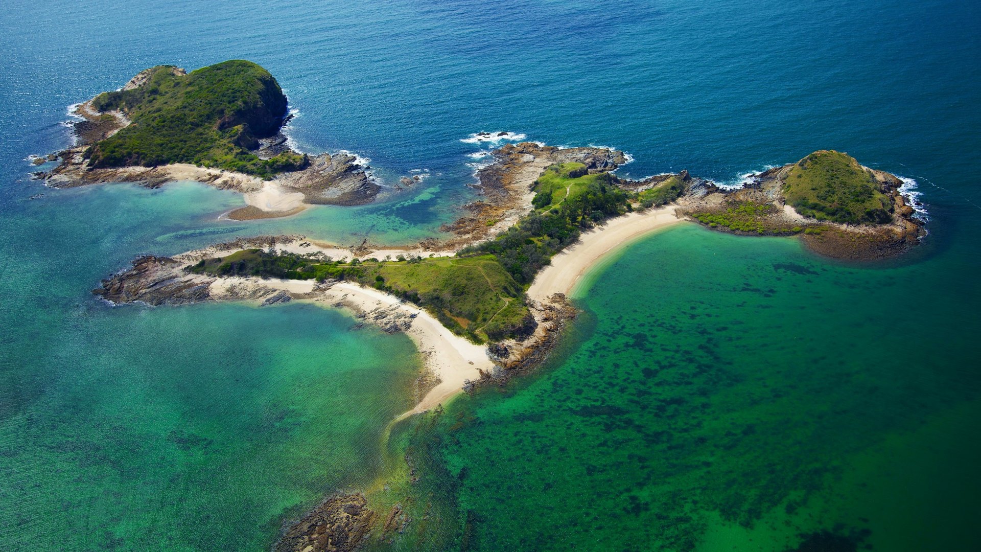 Aerial view of a tropical island with beaches and clear blue water HD Wallpaper