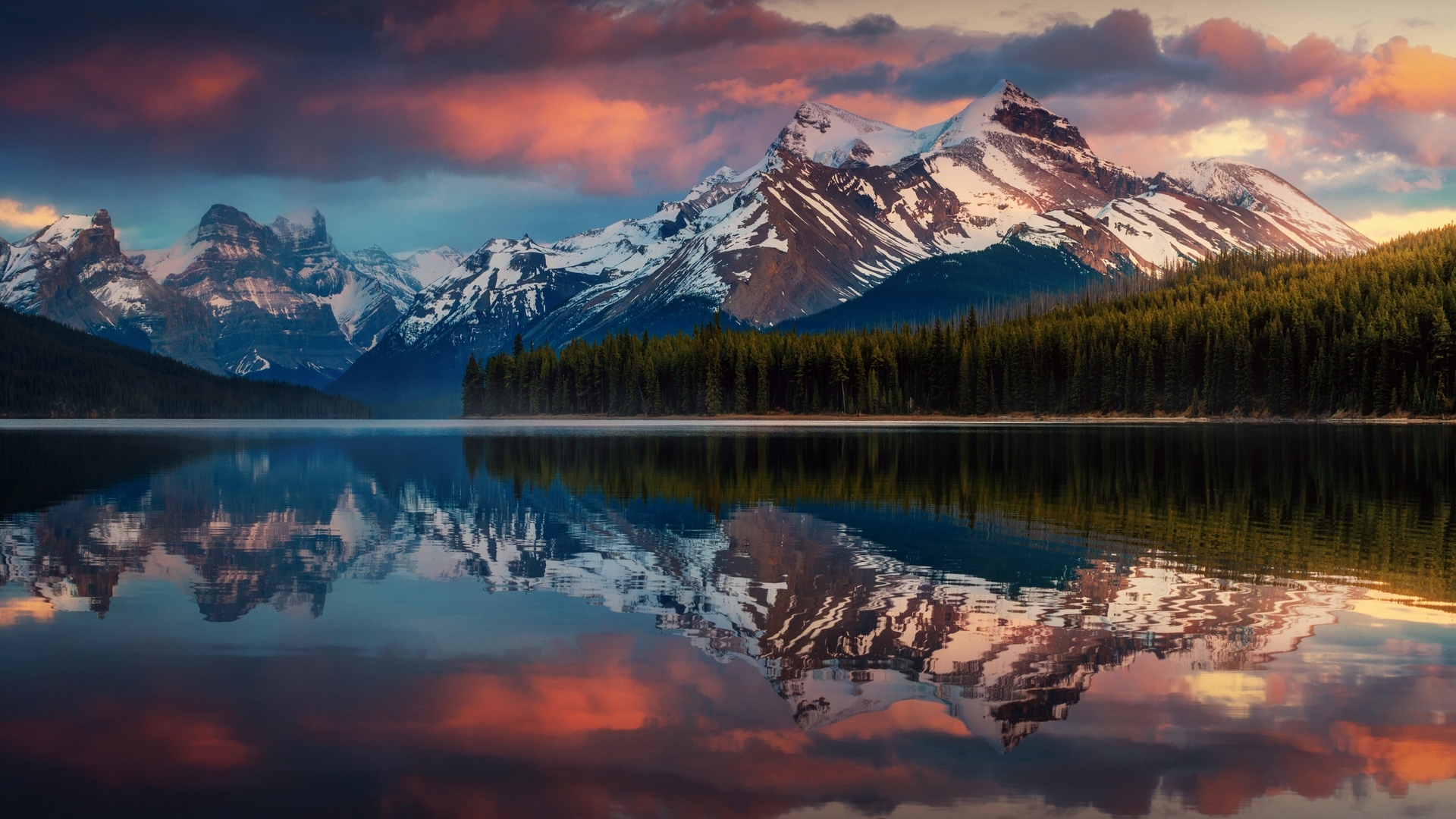 Snow-capped mountains reflected in a calm lake in Alberta, Canada HD Wallpaper