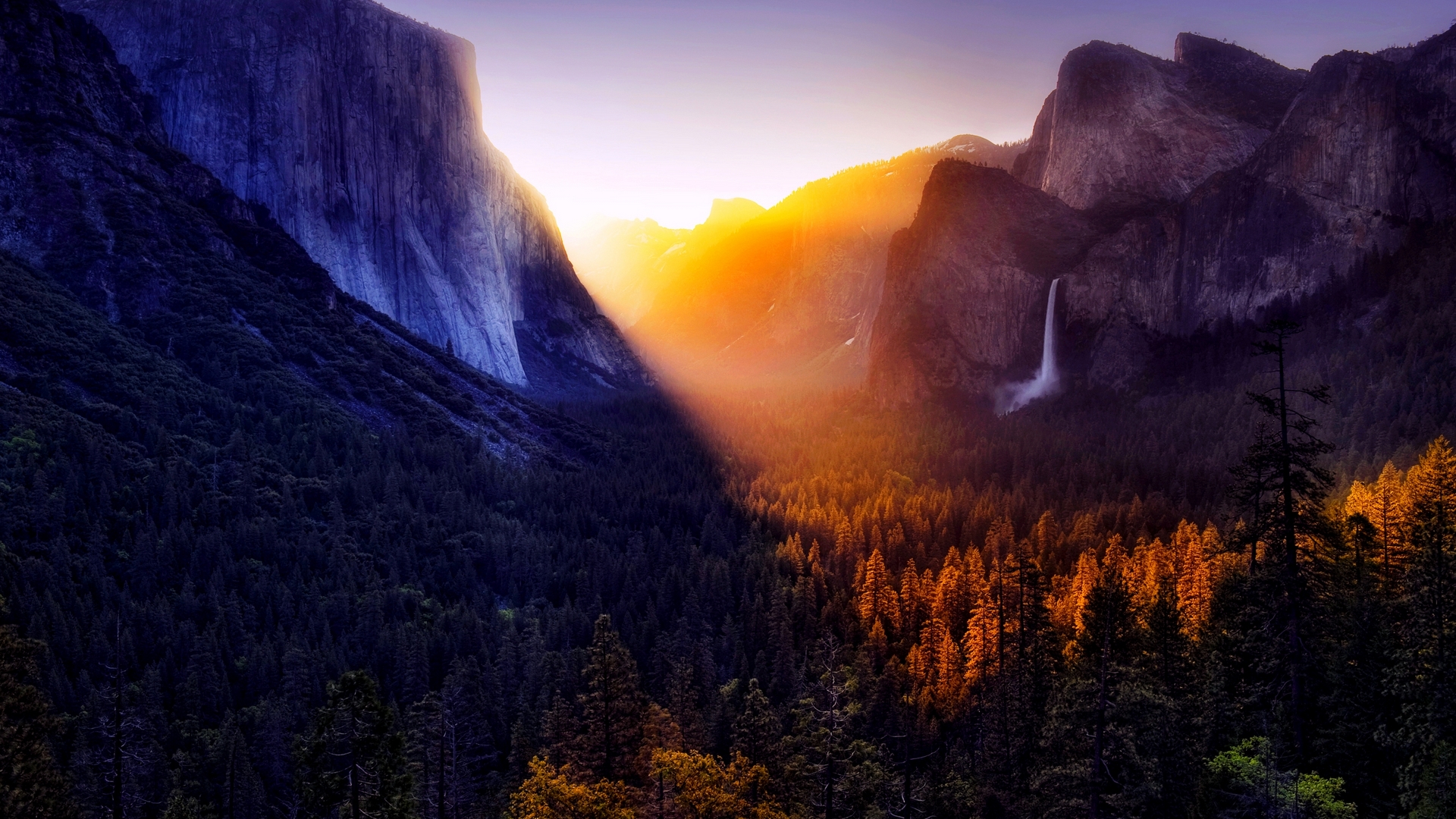 Sunlight Over Forested Mountain Valley with Waterfall HD Wallpaper