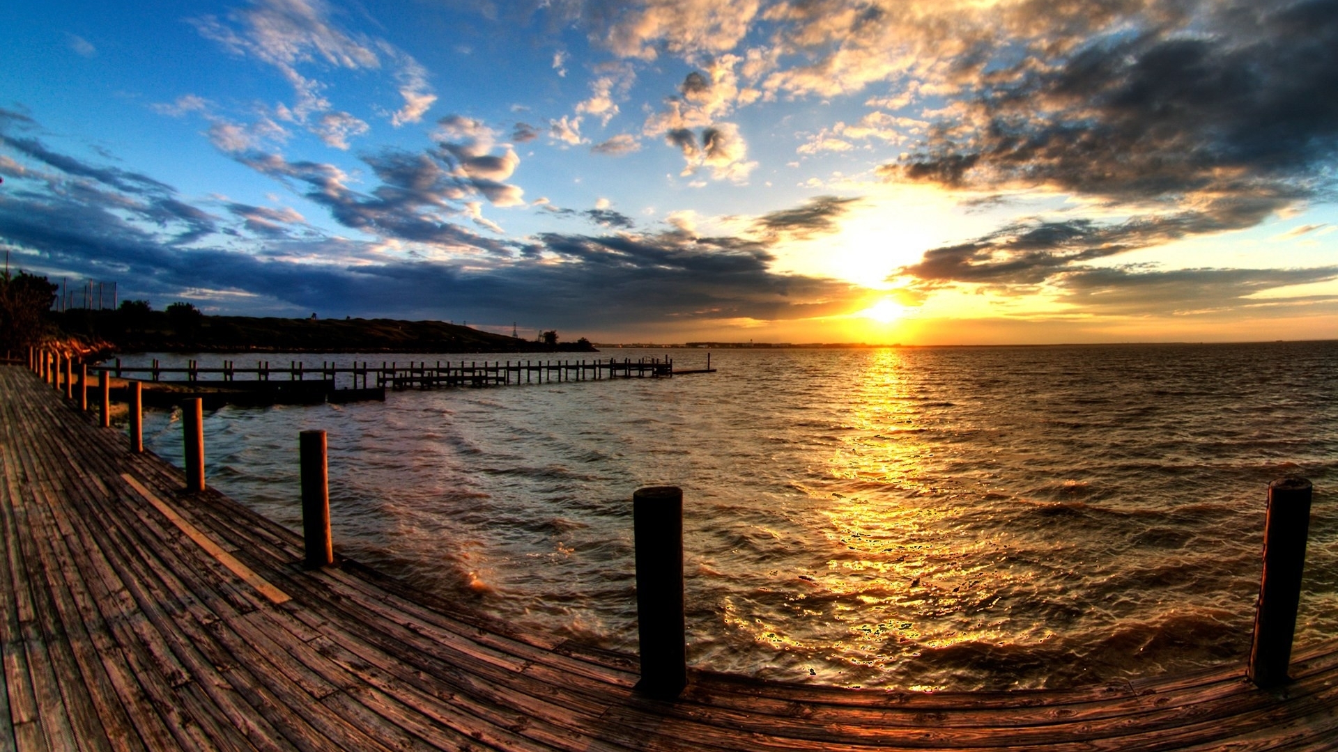 Wooden pier at sunset over the sea with clouds HD Wallpaper