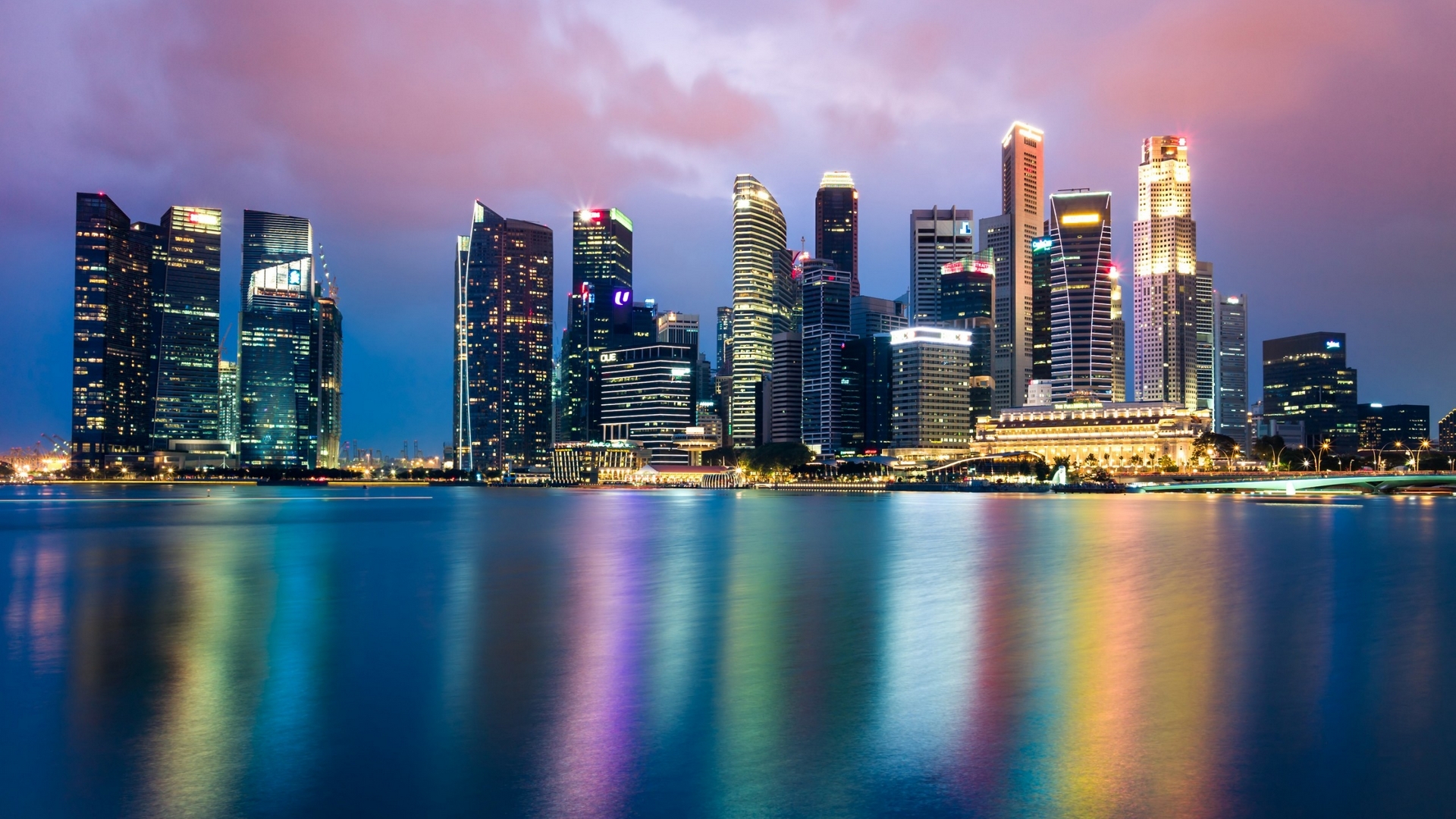 Singapore skyline with skyscrapers and water reflections at dusk HD Wallpaper