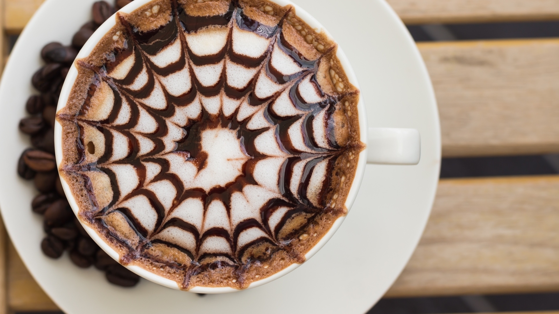 Coffee with chocolate art and beans HD Wallpaper